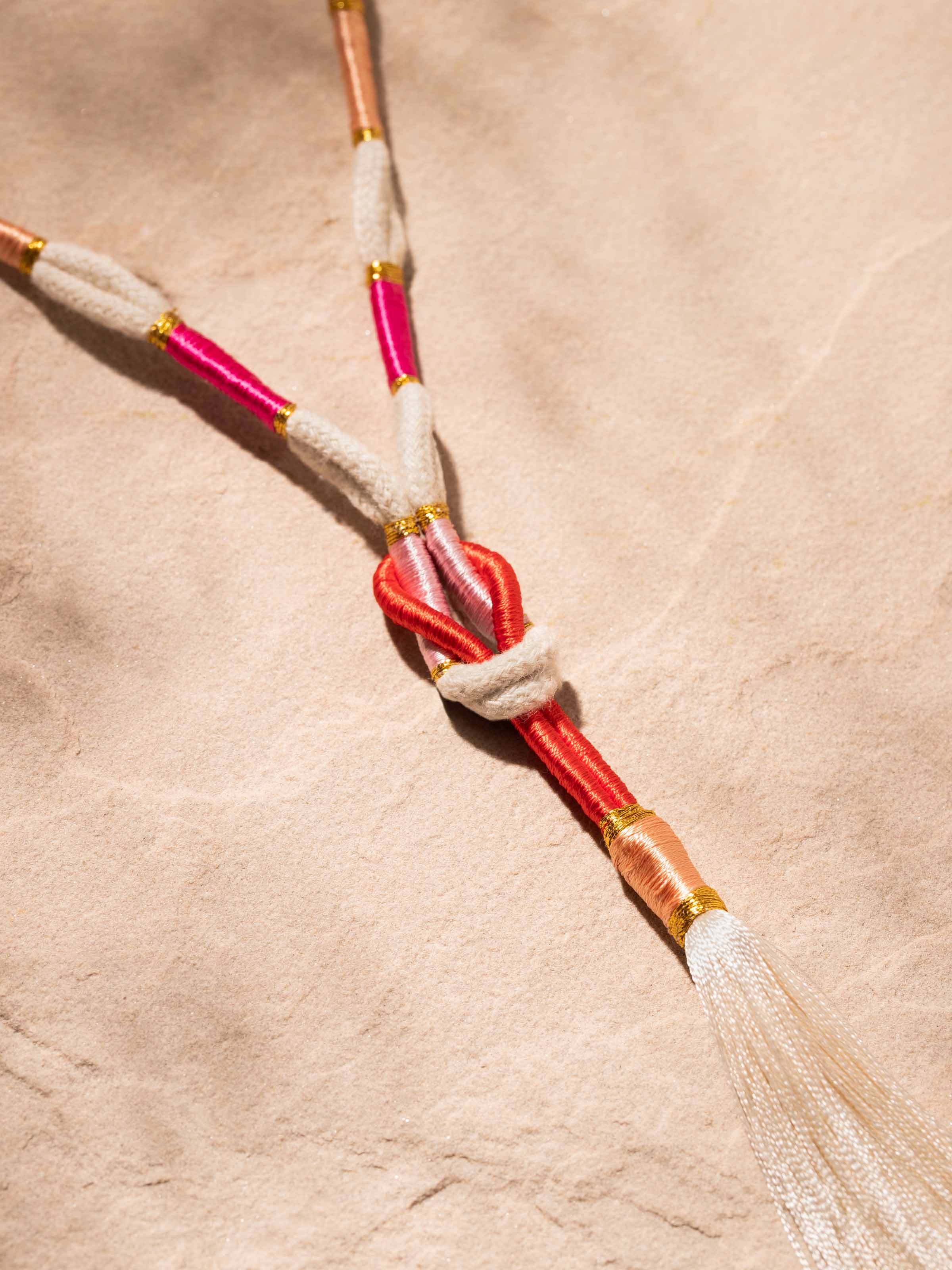 Detailed front view of Patwa long necklace showcasing its intricate patterns and vibrant colors