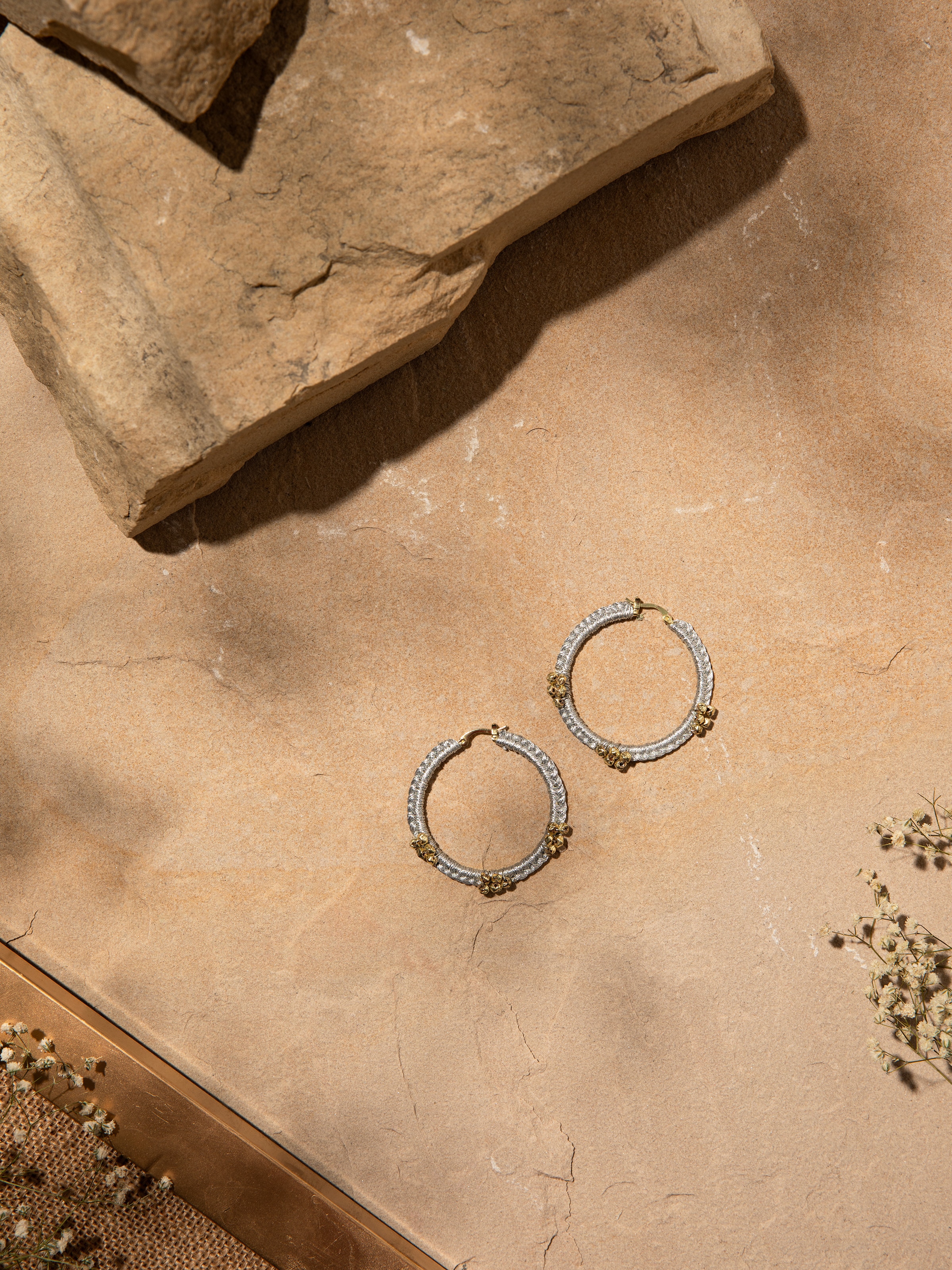 Close-up view of Zari Patwa hoop earrings emphasizing their vibrant threadwork and design