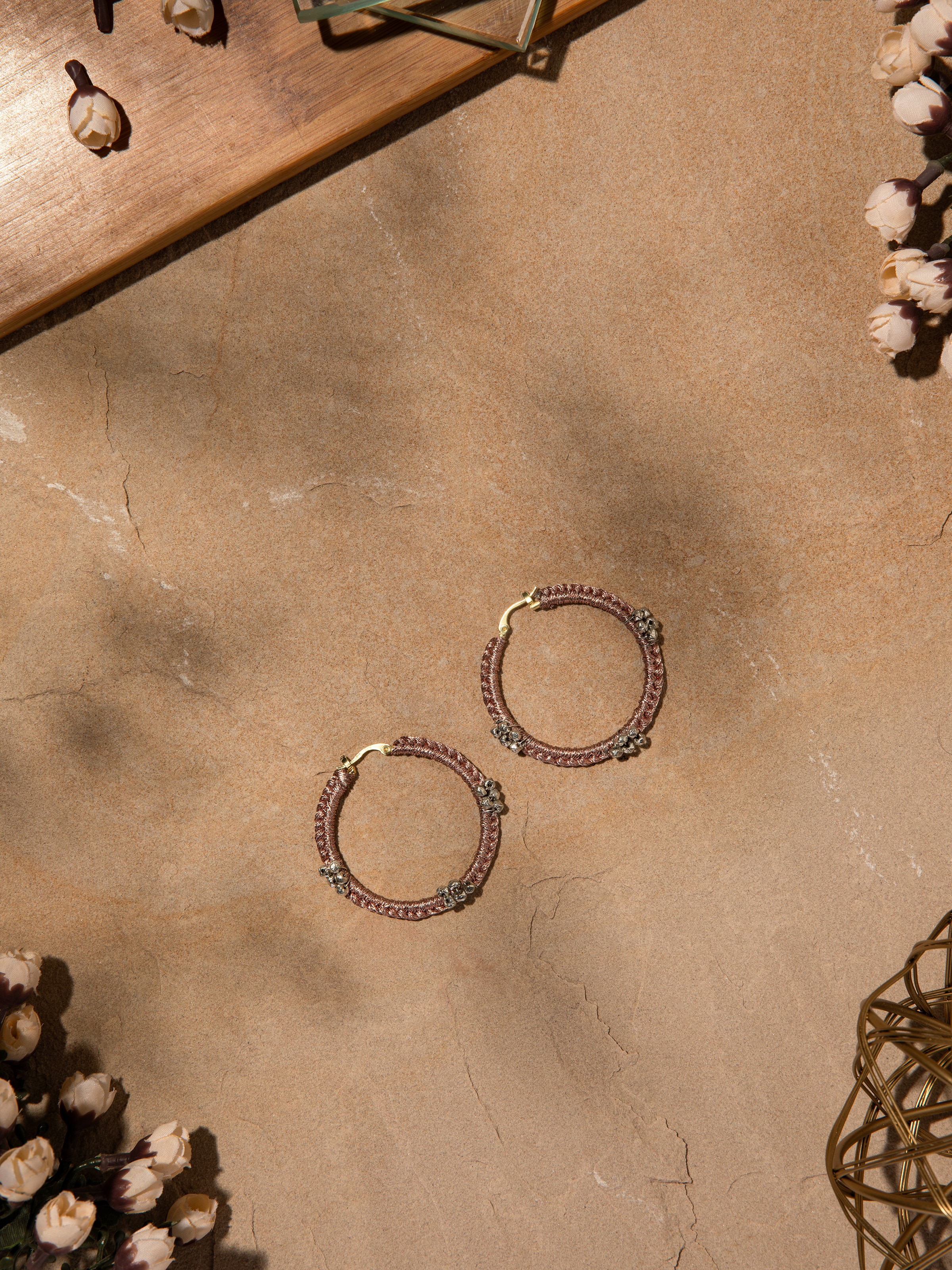 Side angle showing the delicate hoop shape and detailed craftsmanship of the earrings