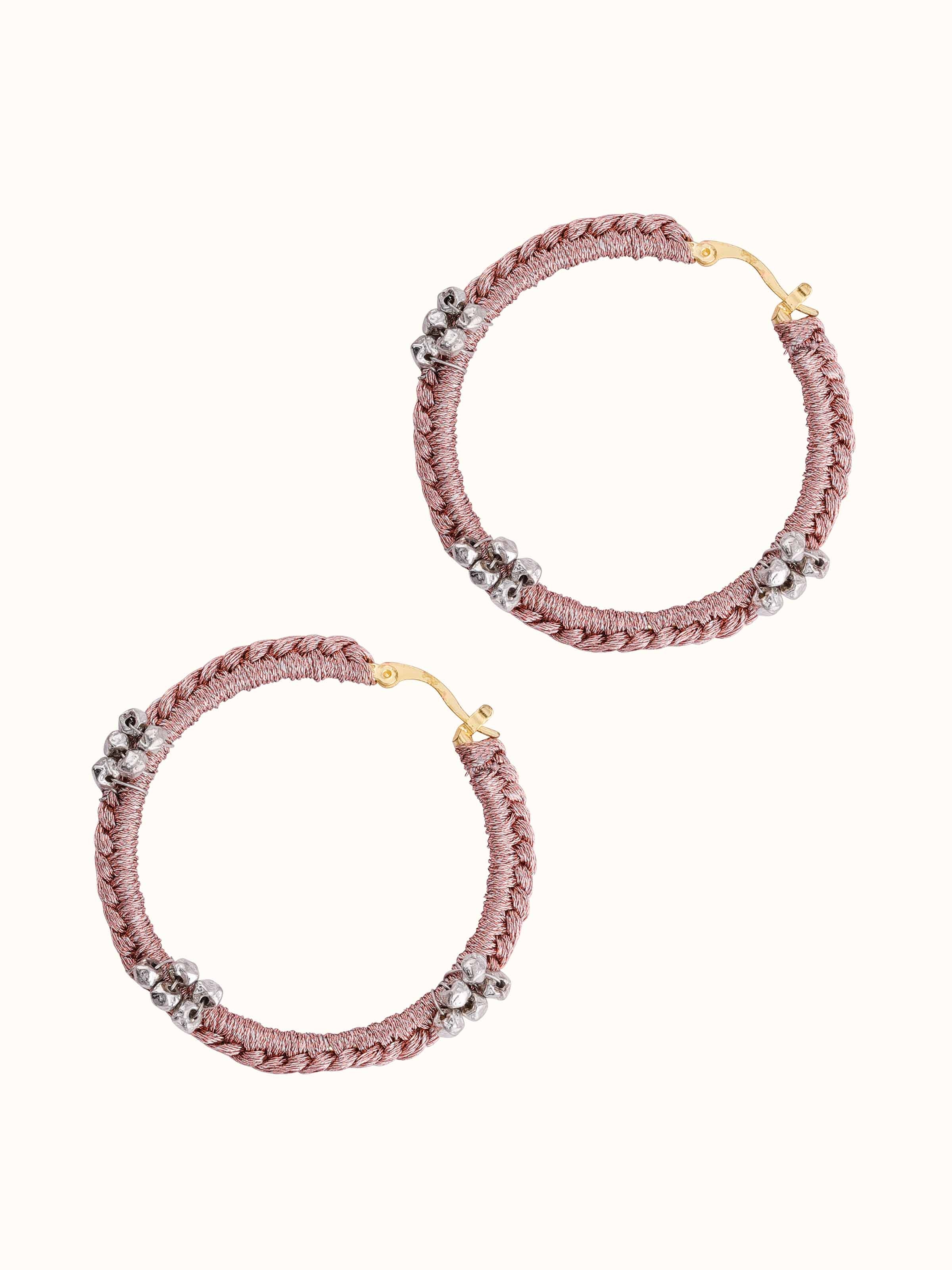 Artistic overhead shot focusing on the elegant design and shine of the hoop earrings