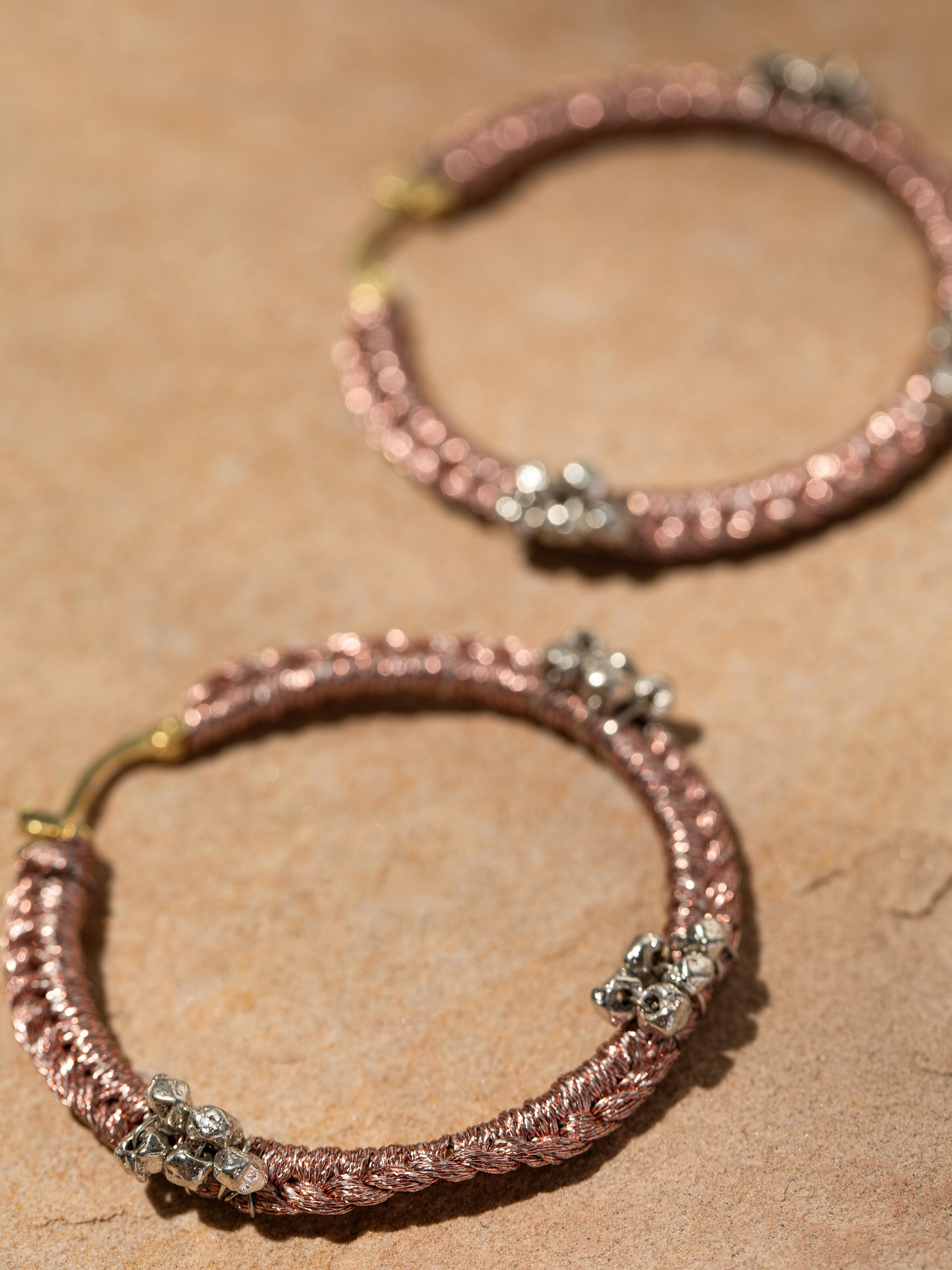 Close-up highlighting the fine zari work and smooth texture on the hoop surface