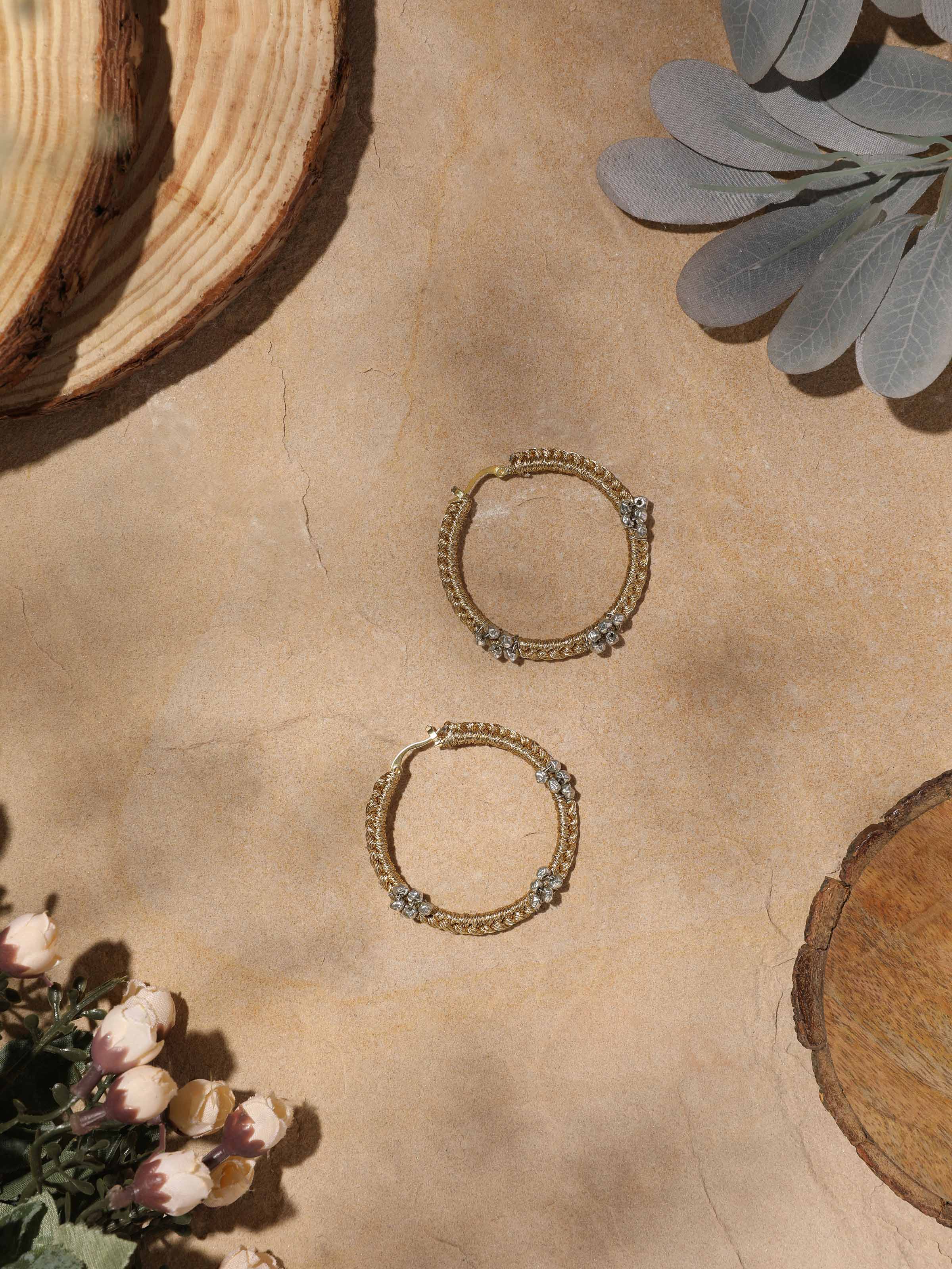 Side view of Zari Patwa hoop earrings highlighting the colorful weaving and elegant round form