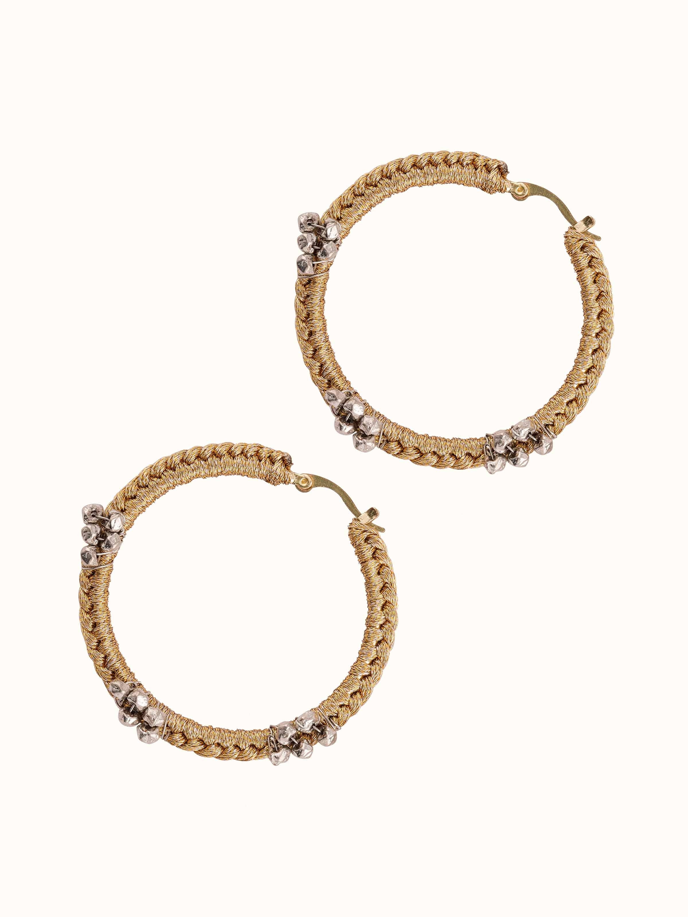 Overhead view of Zari Patwa hoop earrings displaying symmetry and bold color contrasts