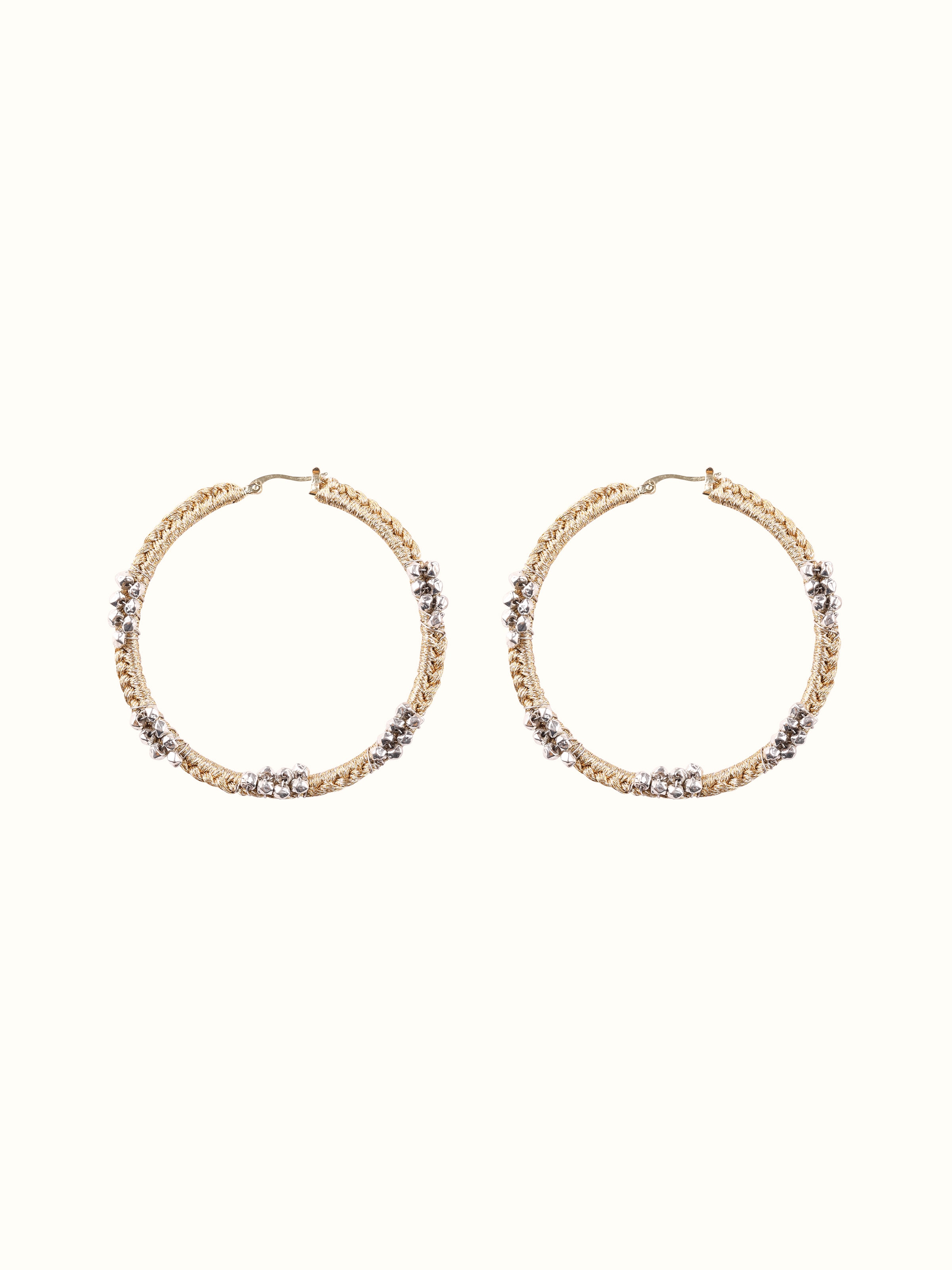 Overhead view of Zari Patwa Hoop Earrings with intricate gold and red embellishments.