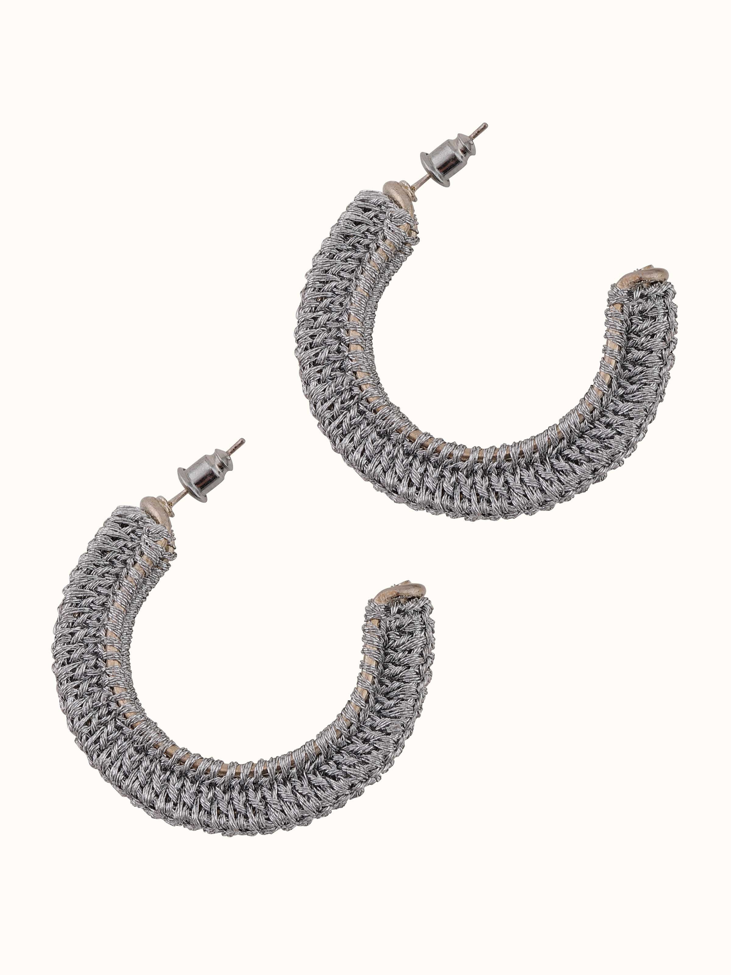 Zari Patwa hoop earrings displayed on a flat surface showcasing their detailed design and elegant finish.