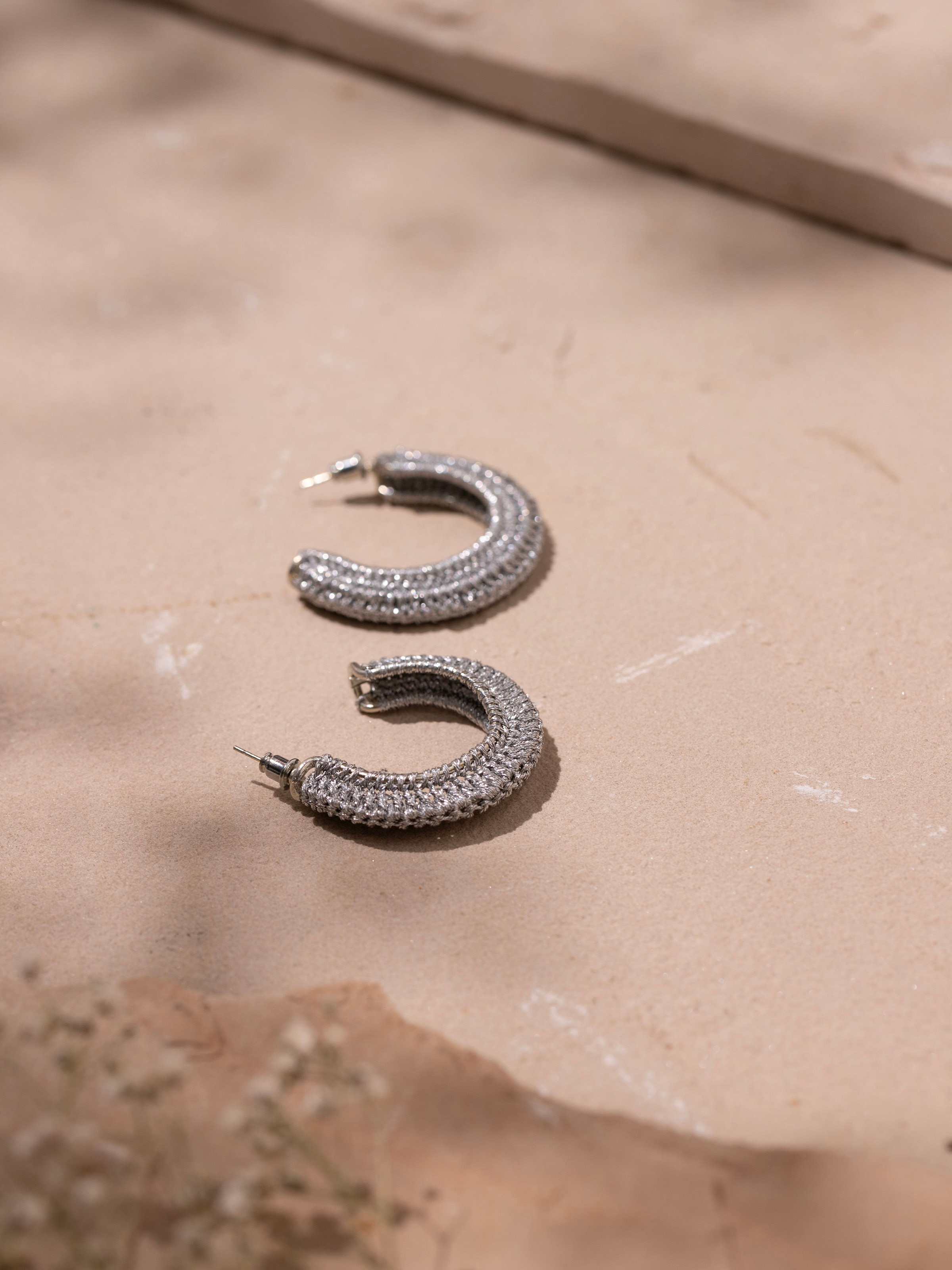 Detailed view of Zari Patwa hoop earrings illustrating their intricate design and traditional craftsmanship.