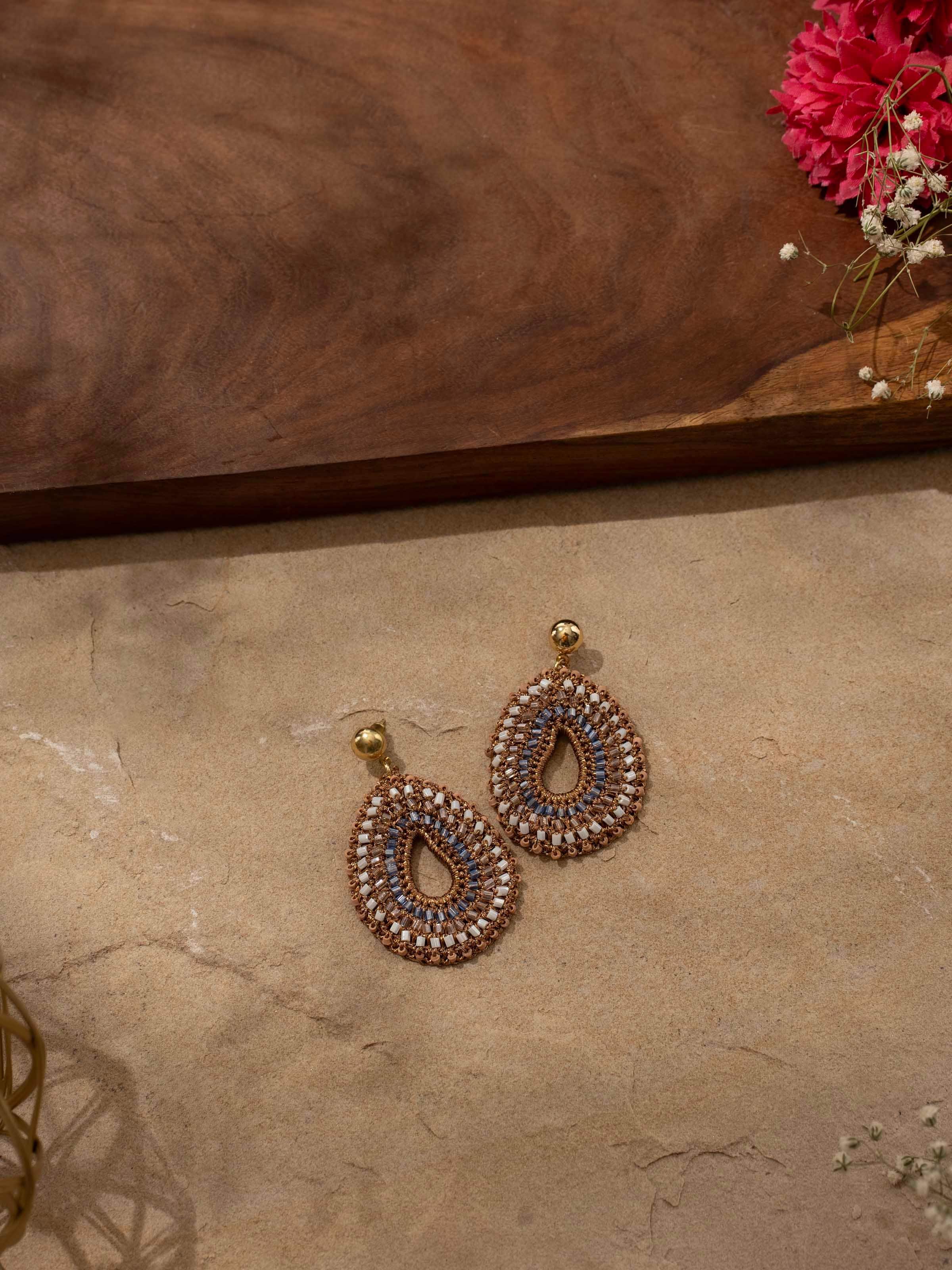 Close-up side angle highlighting intricate embroidery and drop design of Zari Patwa earrings