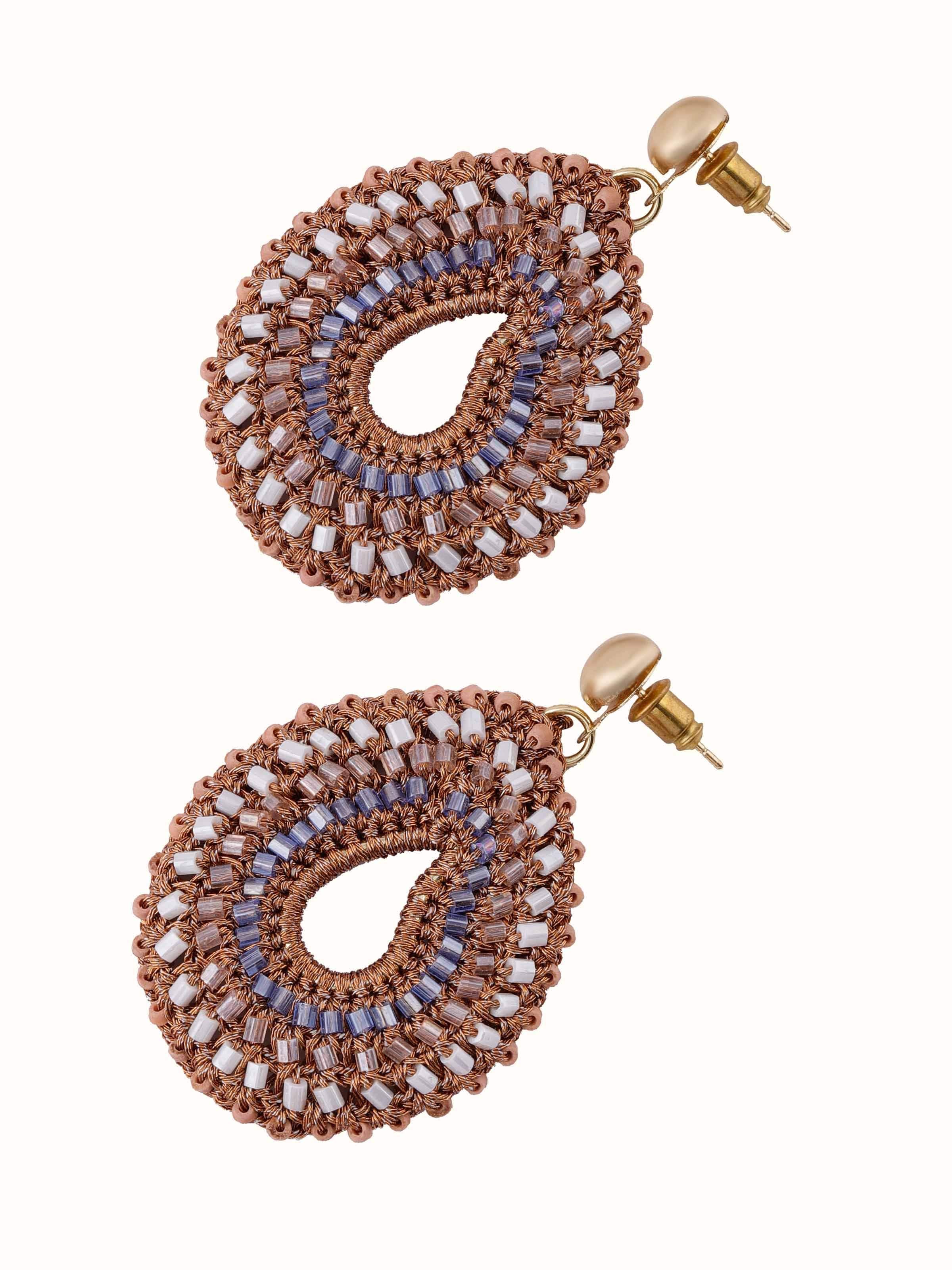 Artistic close-up emphasizing gold zari thread work and elegant drop shape