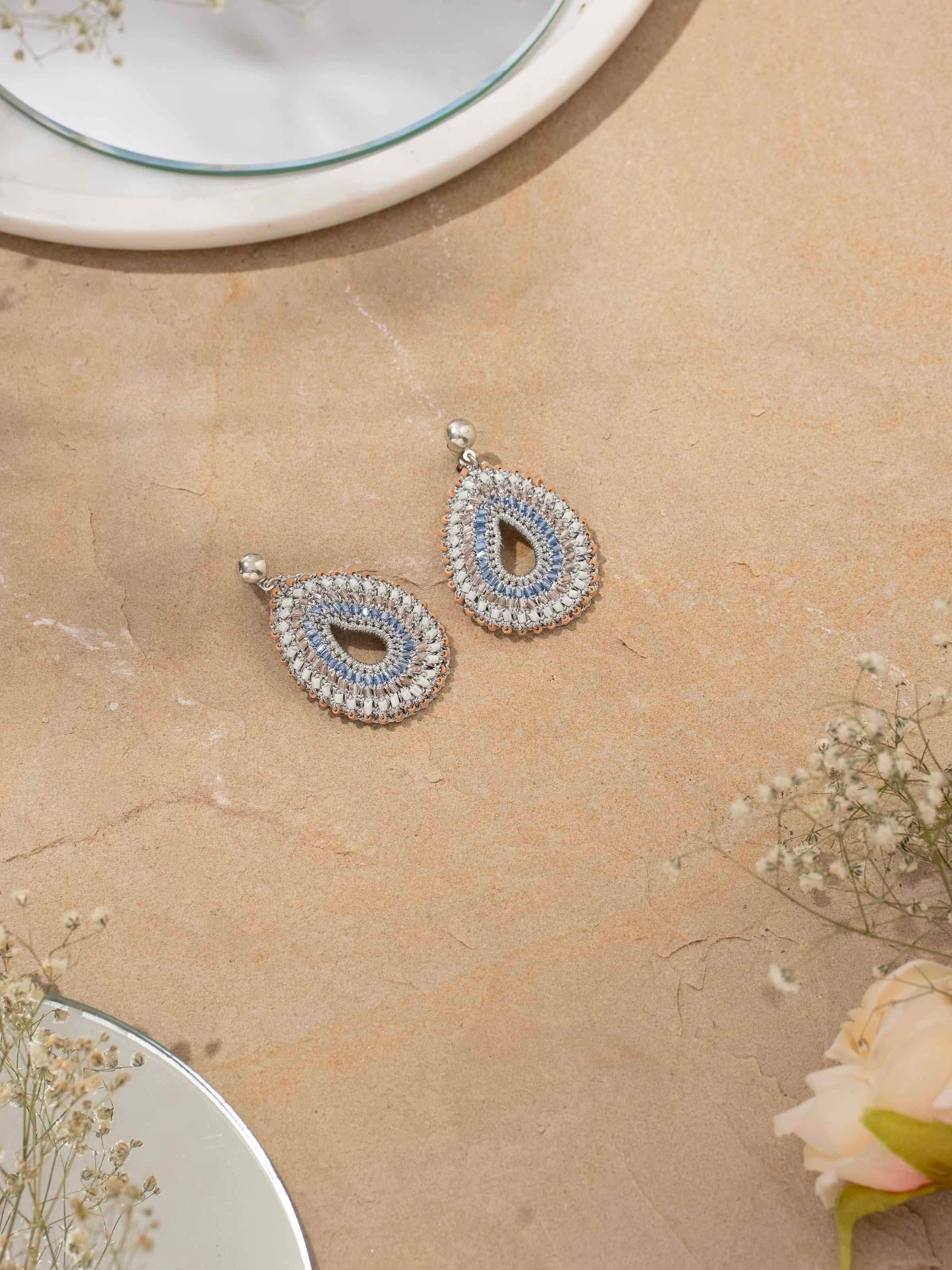 Top view of Zari Patwa drop earrings featuring fine gold thread work and elegant design.