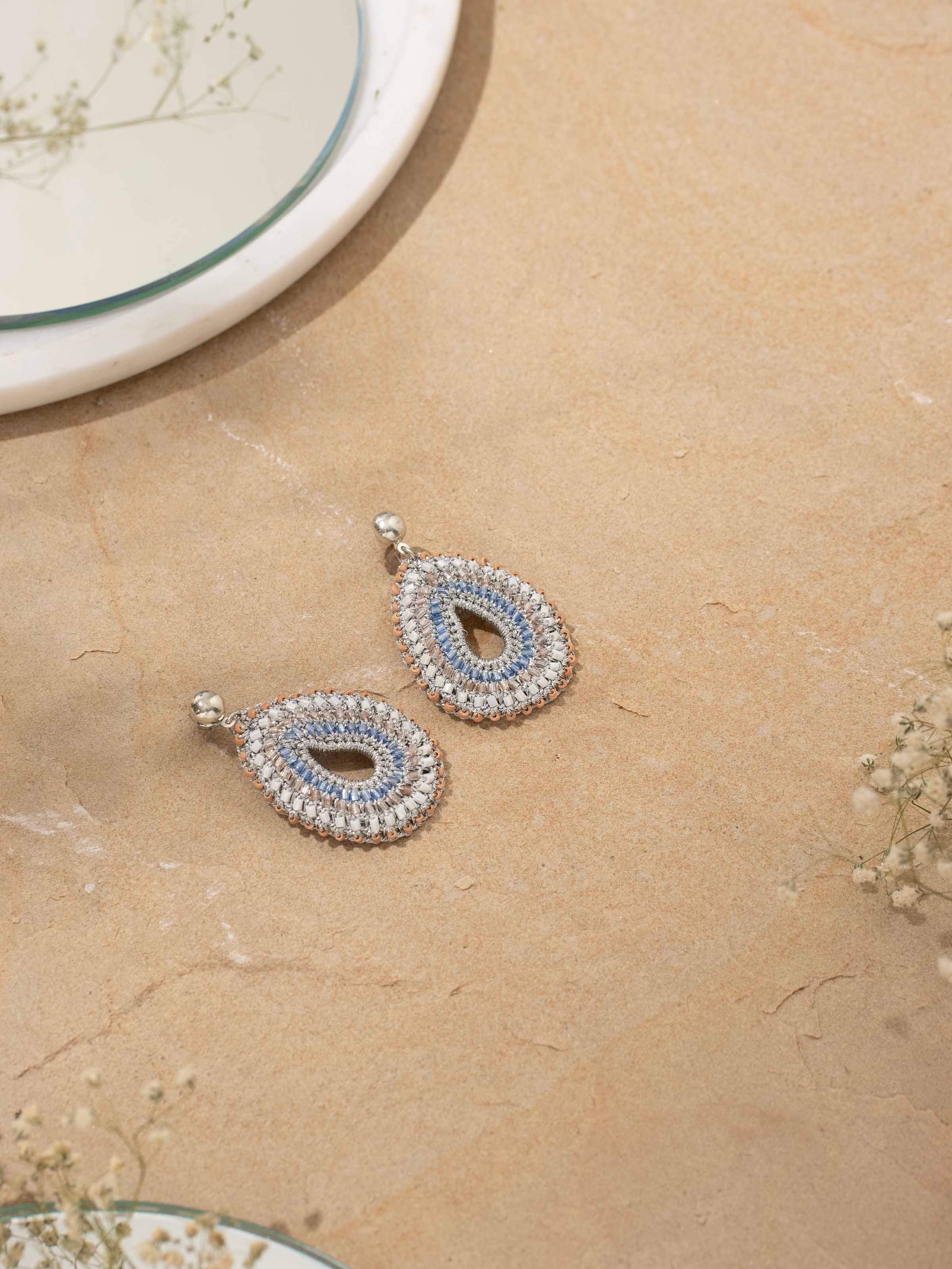 Detailed top view of Zari Patwa drop earrings showcasing intricate gold thread embroidery and delicate craftsmanship.