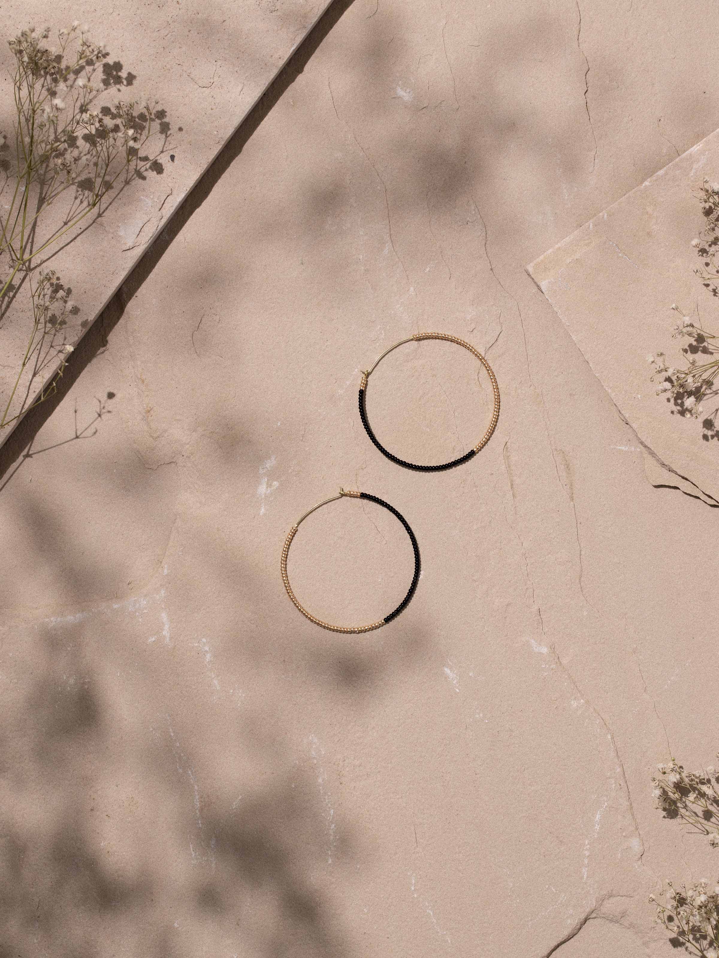 Close-up view of Handcrafted Hoop Earrings emphasizing detailed metalwork and artisanal quality.