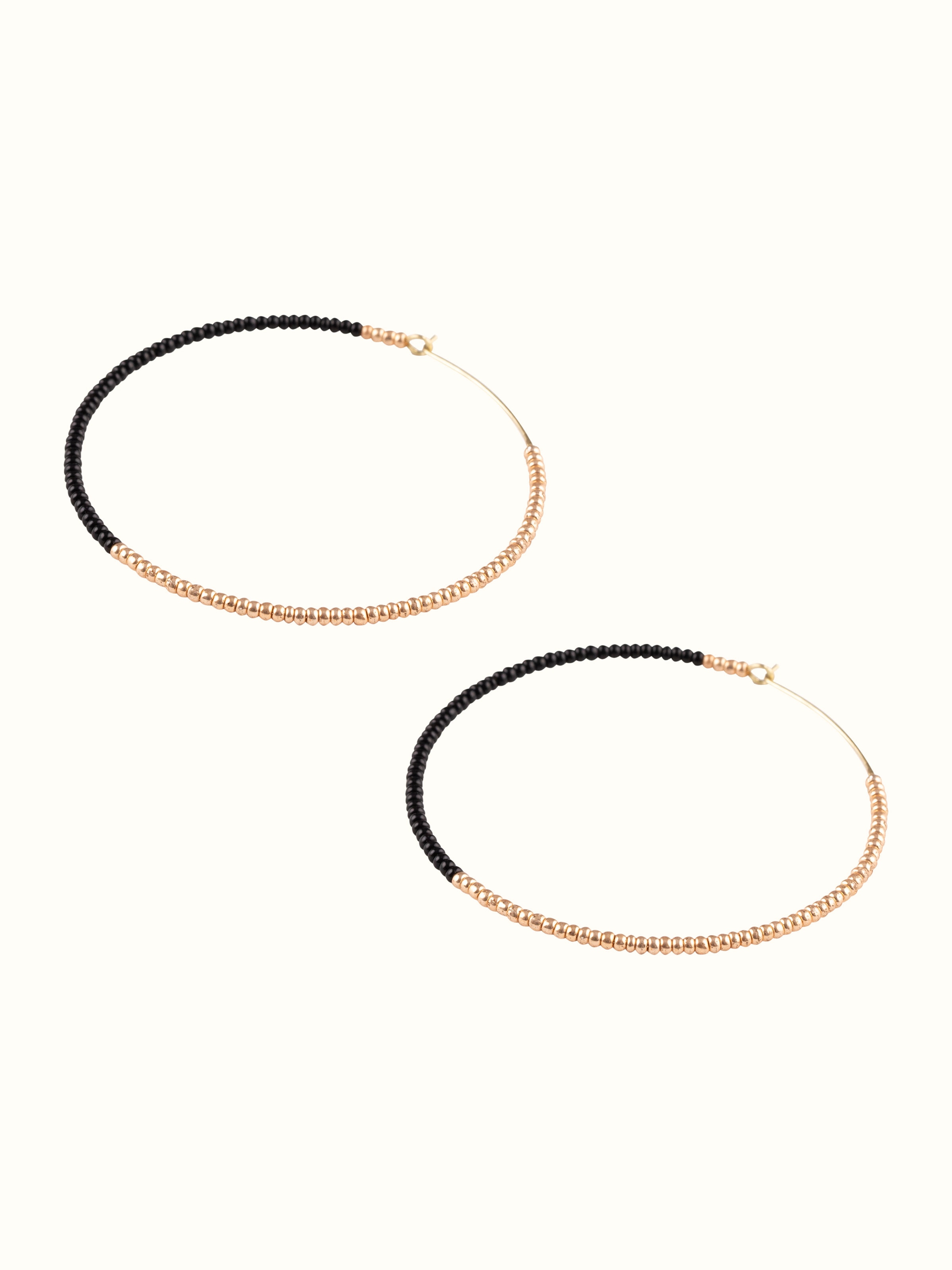 Angled view of Handcrafted Hoop Earrings highlighting the elegant curves and detailed design.