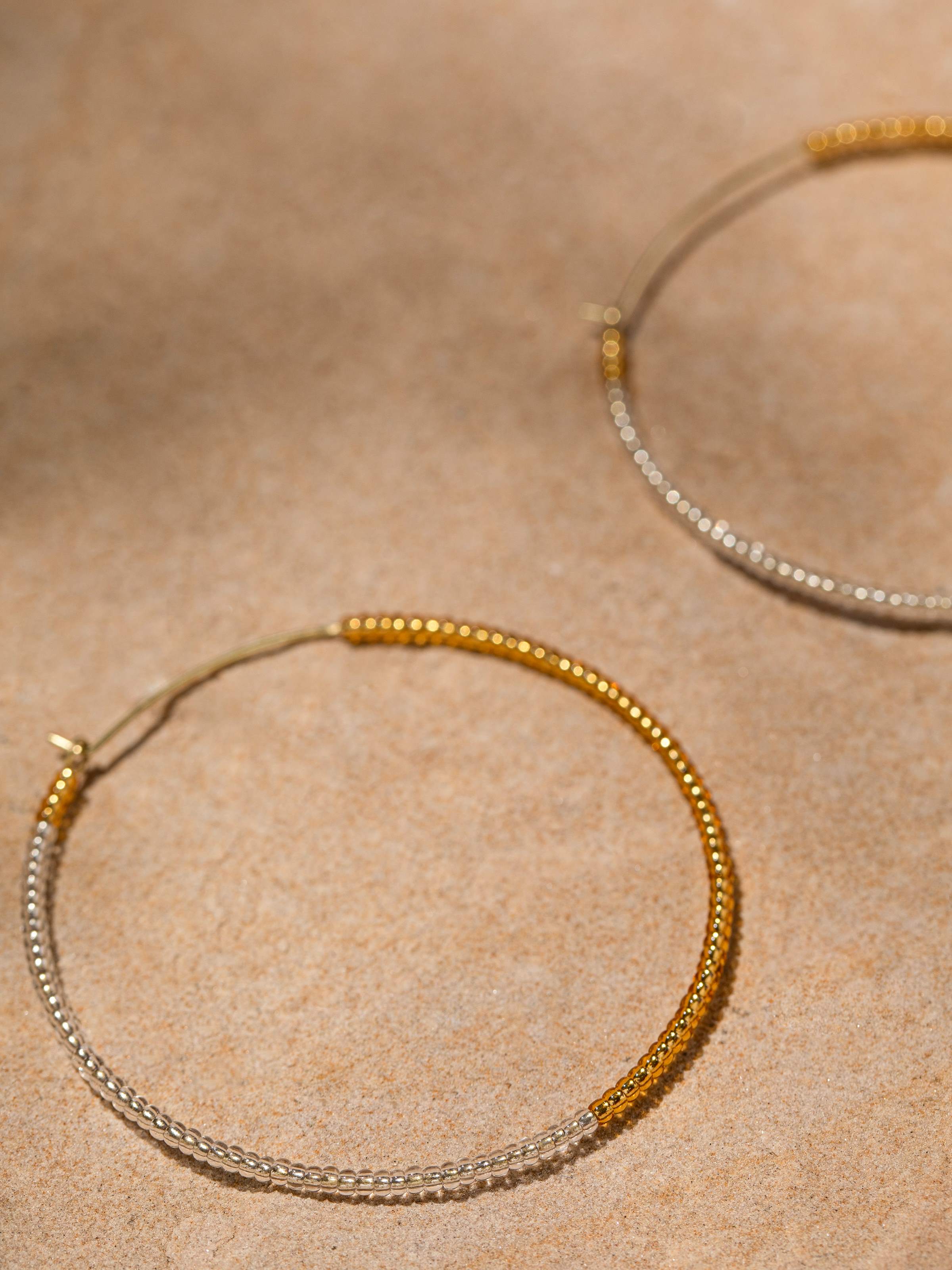 Detailed front view of handcrafted hoop earrings showcasing their unique style