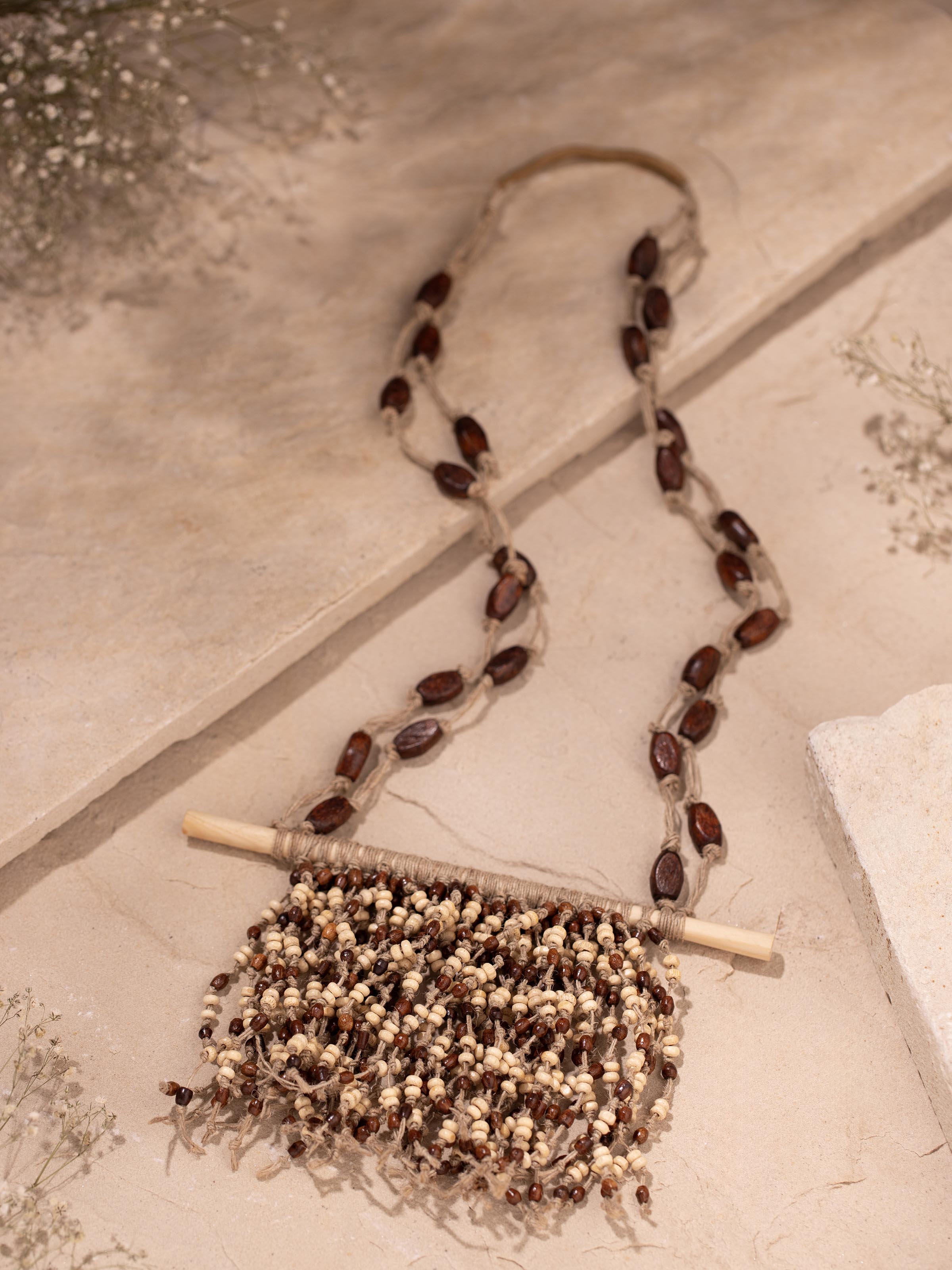 Side view of Jute Long Necklace highlighting its length and natural texture.