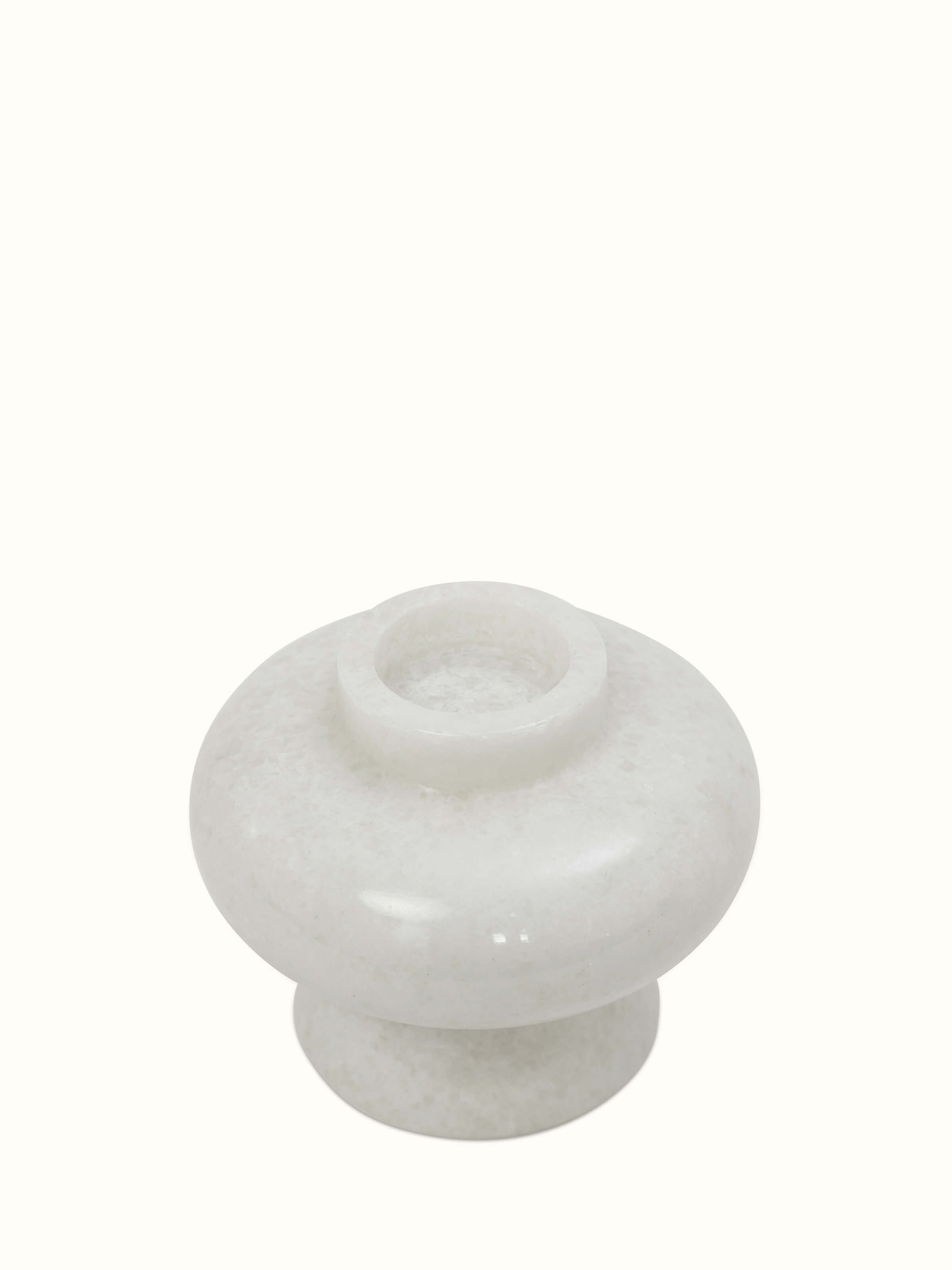 Angled view of Carved marble tea light holder in white color showcasing the intricate carvings and polished marble surface.