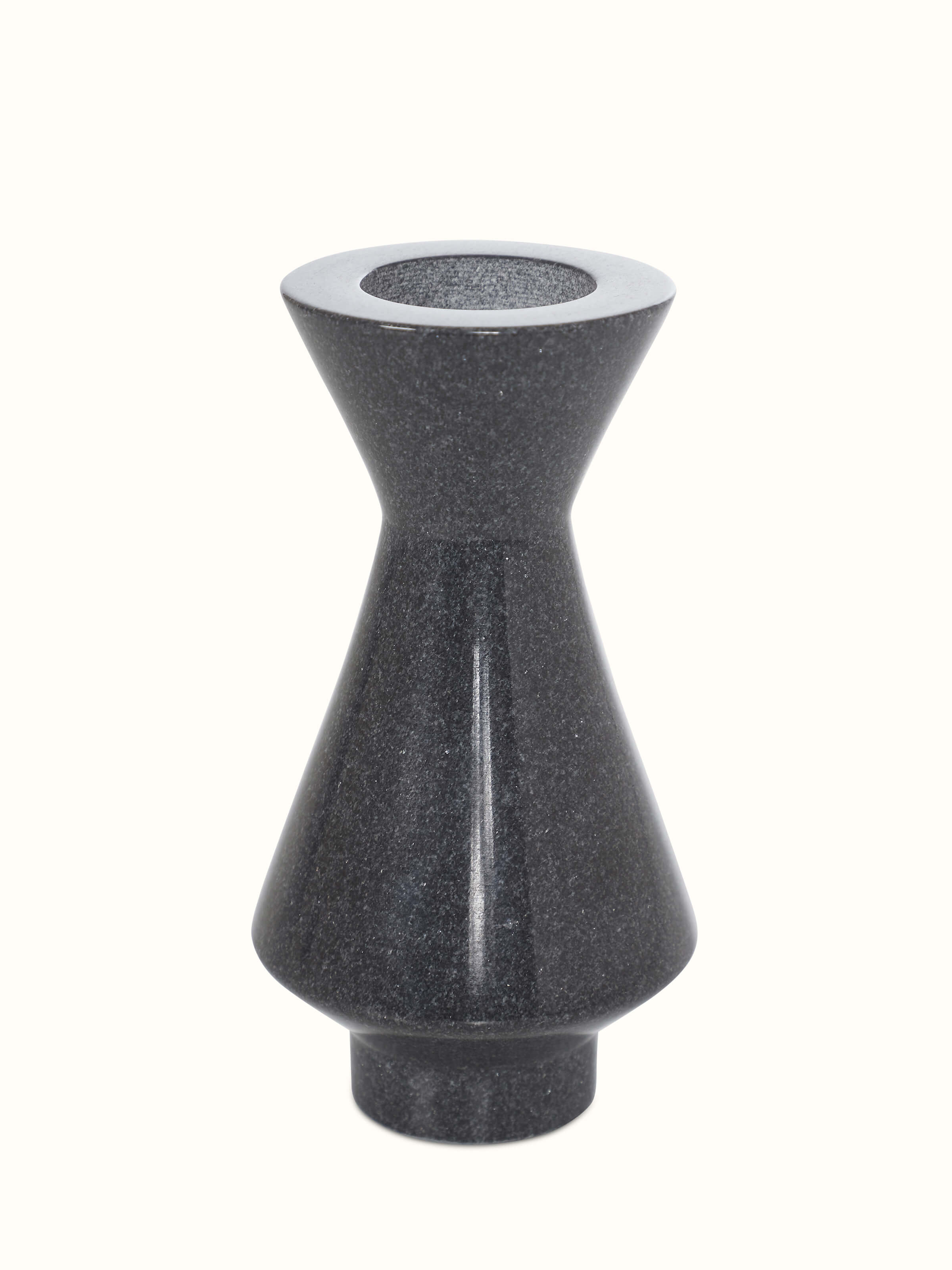 Side view of carved black marble candle holders, highlighting the elegant design and detailing.