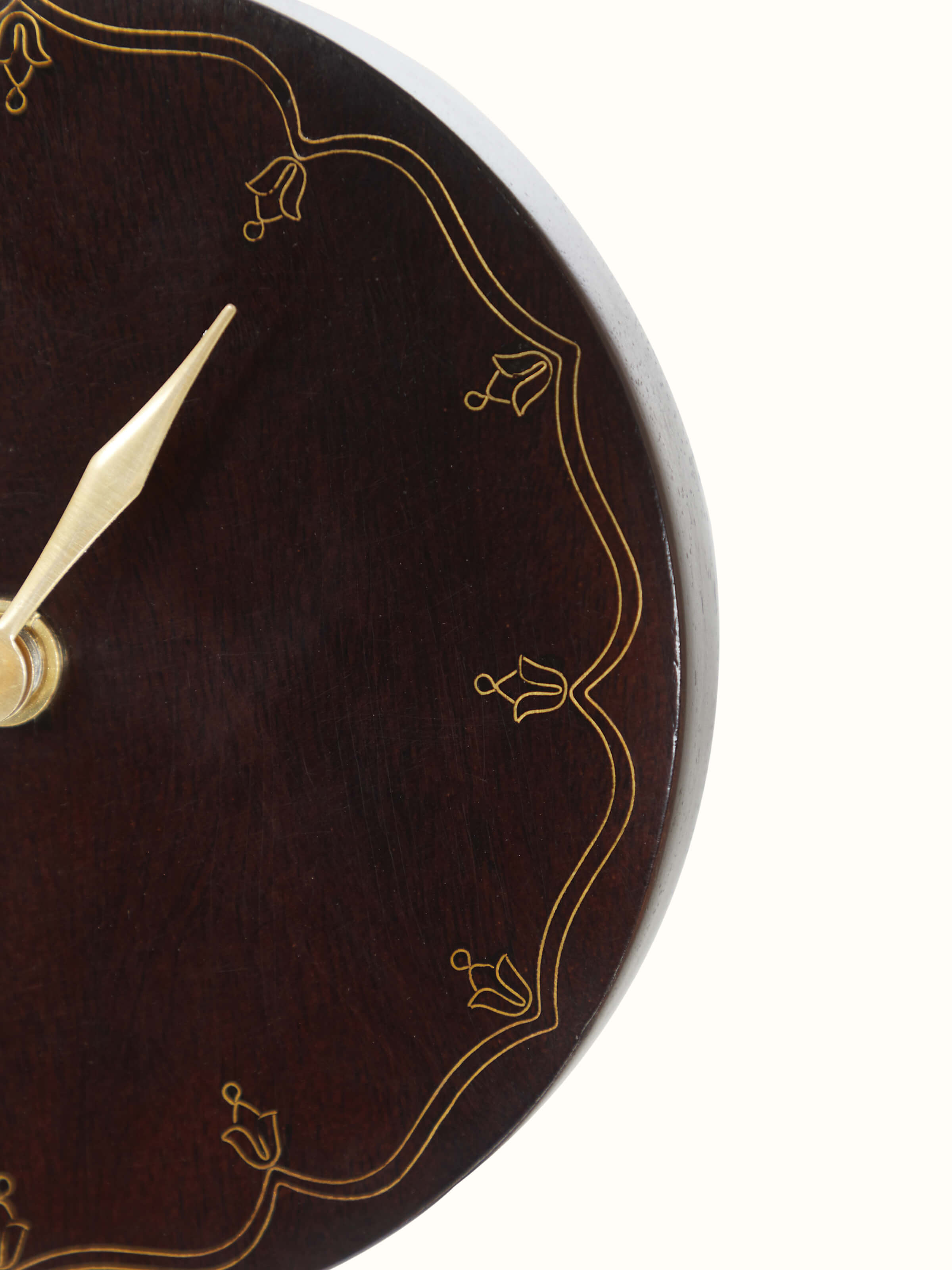 Close-up view of natural tarkashi sheesham wood & brass table clock, focusing on the fine brass inlay work and rich wood texture