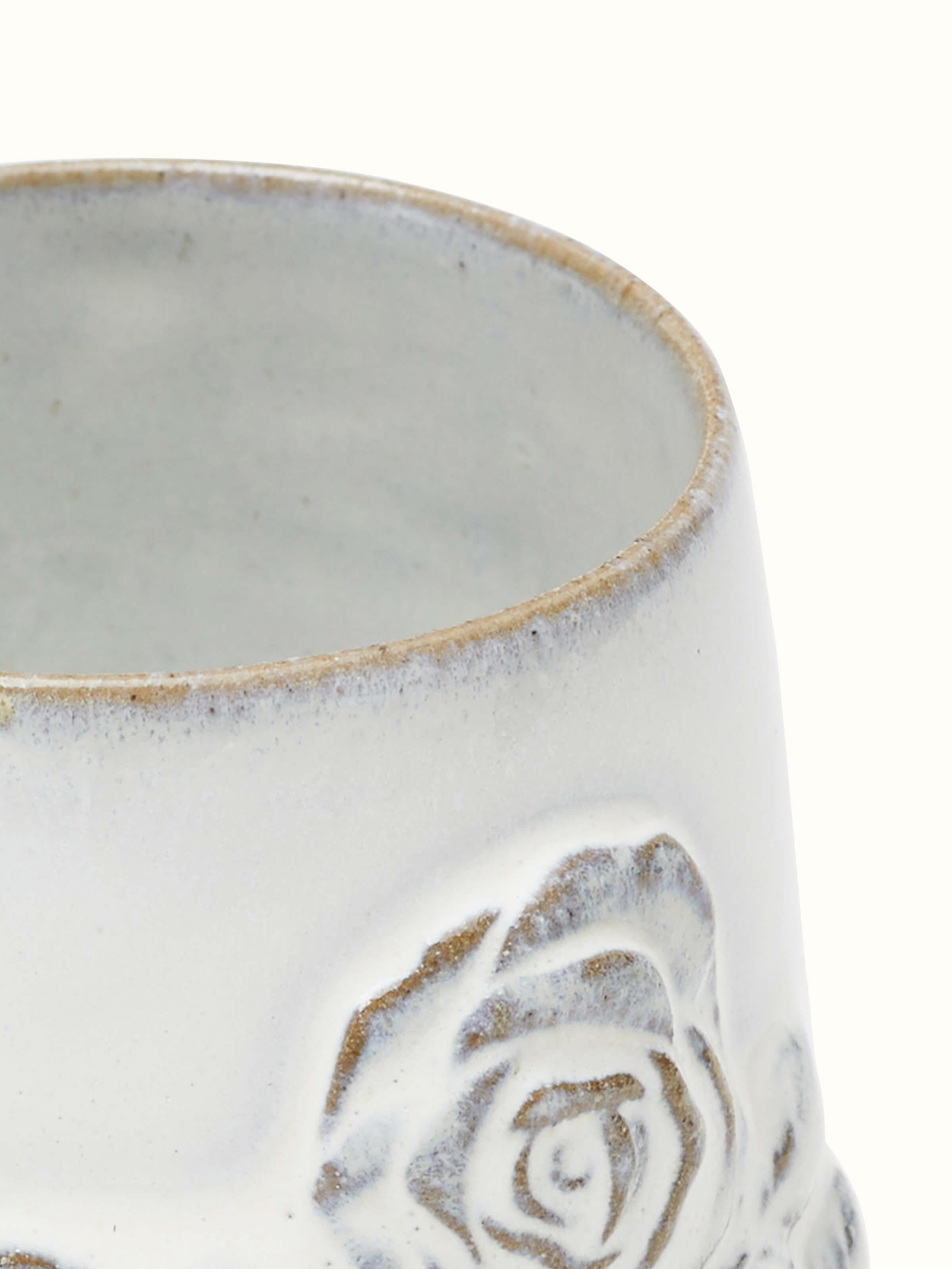 Close-up of Studio pottery ceramic coffee mug white displaying texture