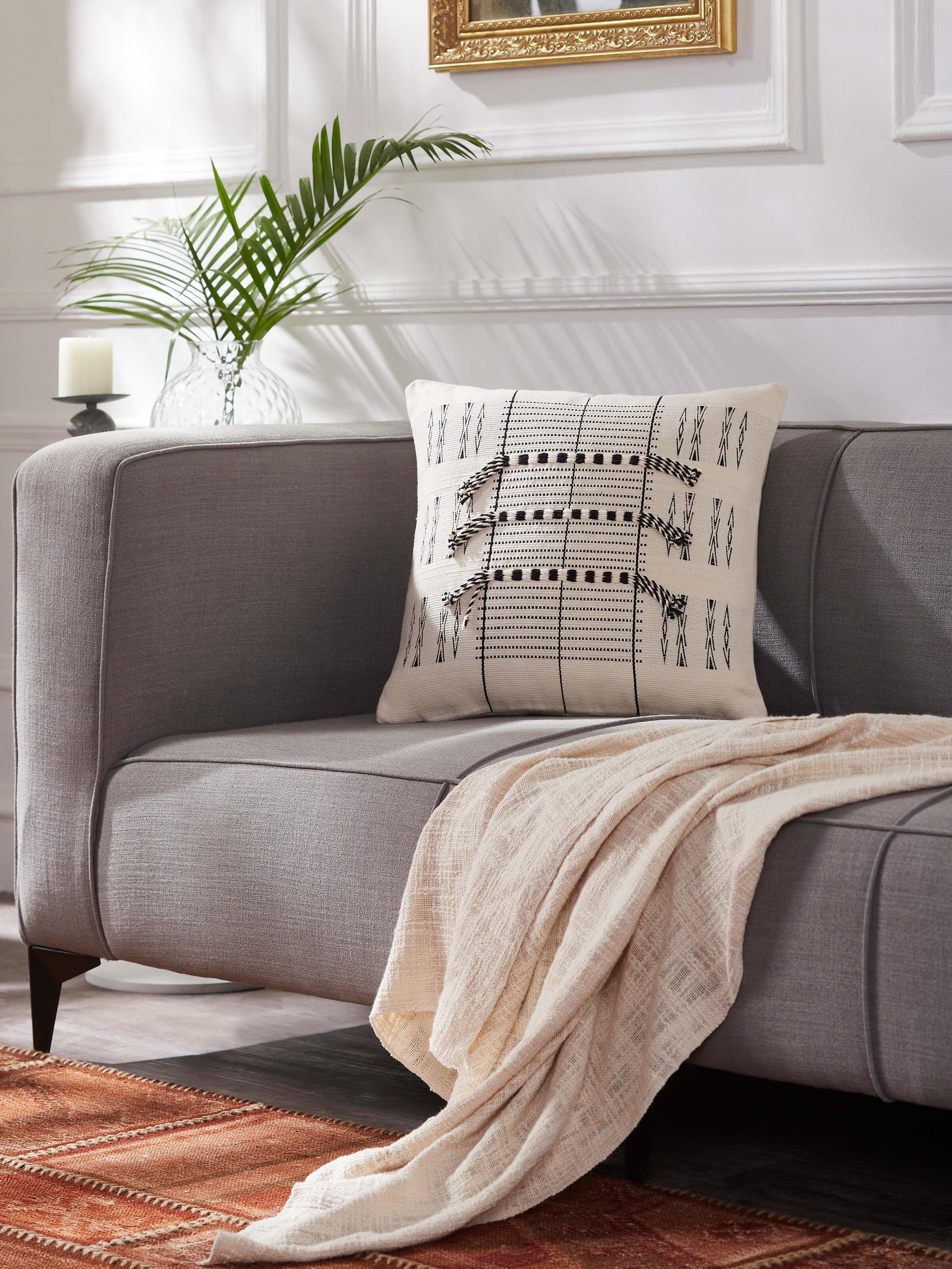 Close-up of Ridhama White Lanka Cotton Naga Handloom Cushion Cover, highlighting the detailed handloom craftsmanship.