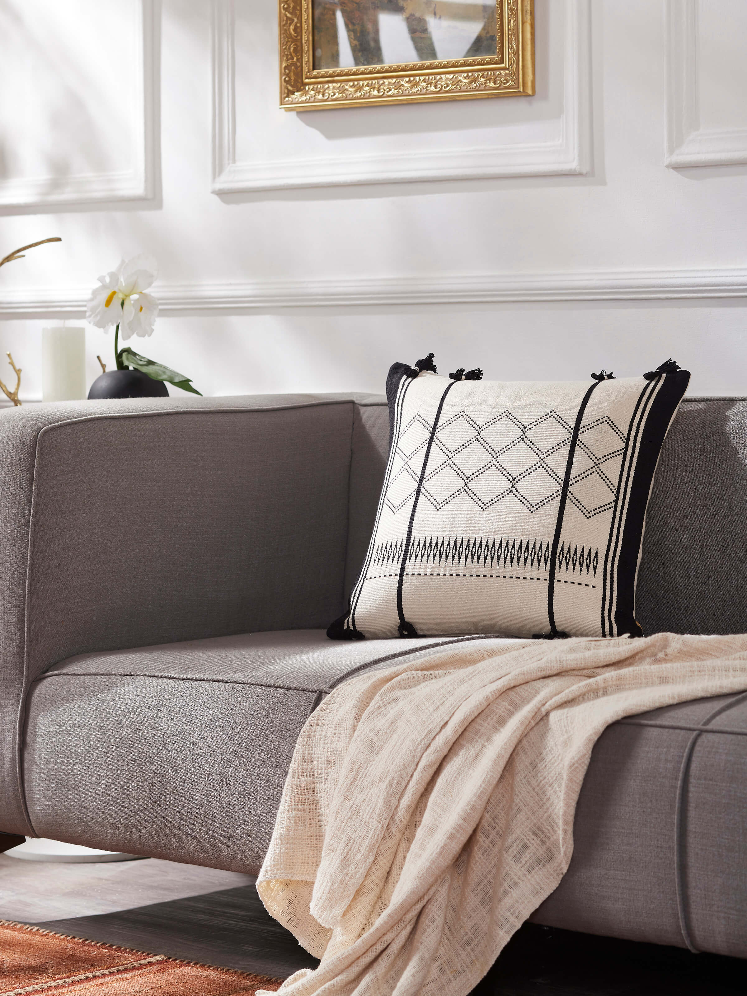 Lifestyle view of Ridhima ivory cushion cover adding a handcrafted touch to contemporary decor