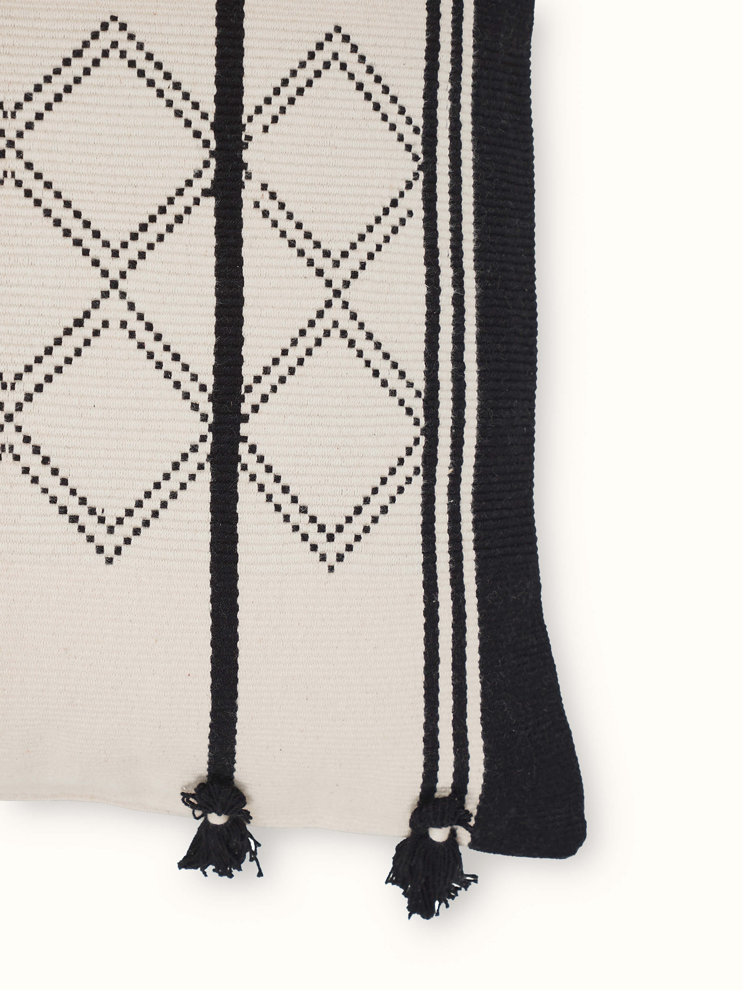 Angled view highlighting the textured pattern and fine cotton weave of the Naga handloom cushion cover