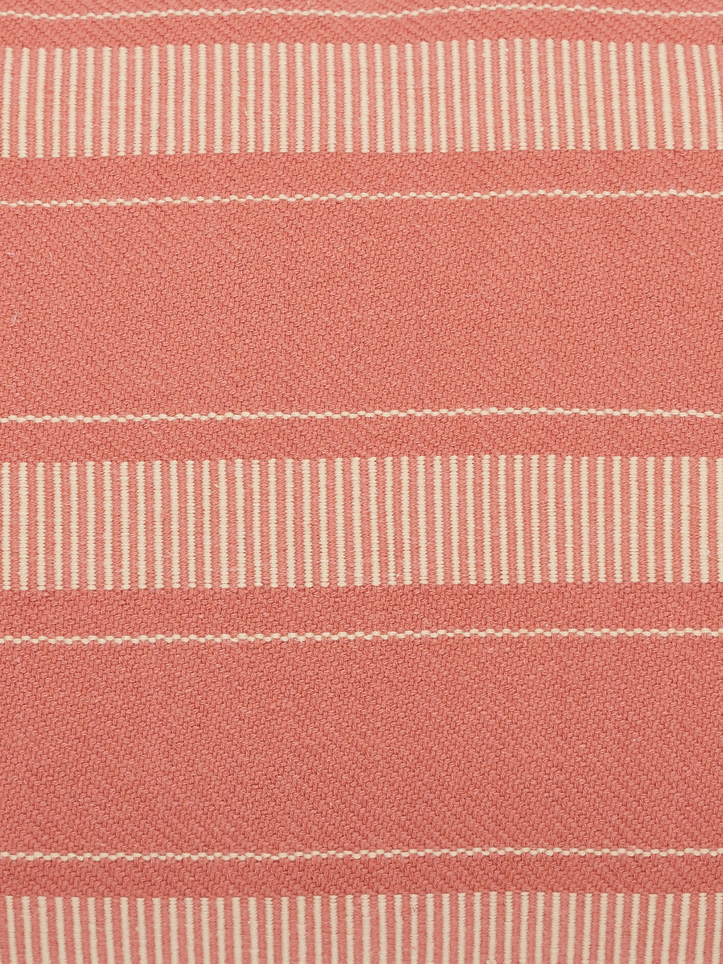 Detailed view of Godna peach stripe cotton handwoven pattu cushion cover showing the texture and color of the fabric.