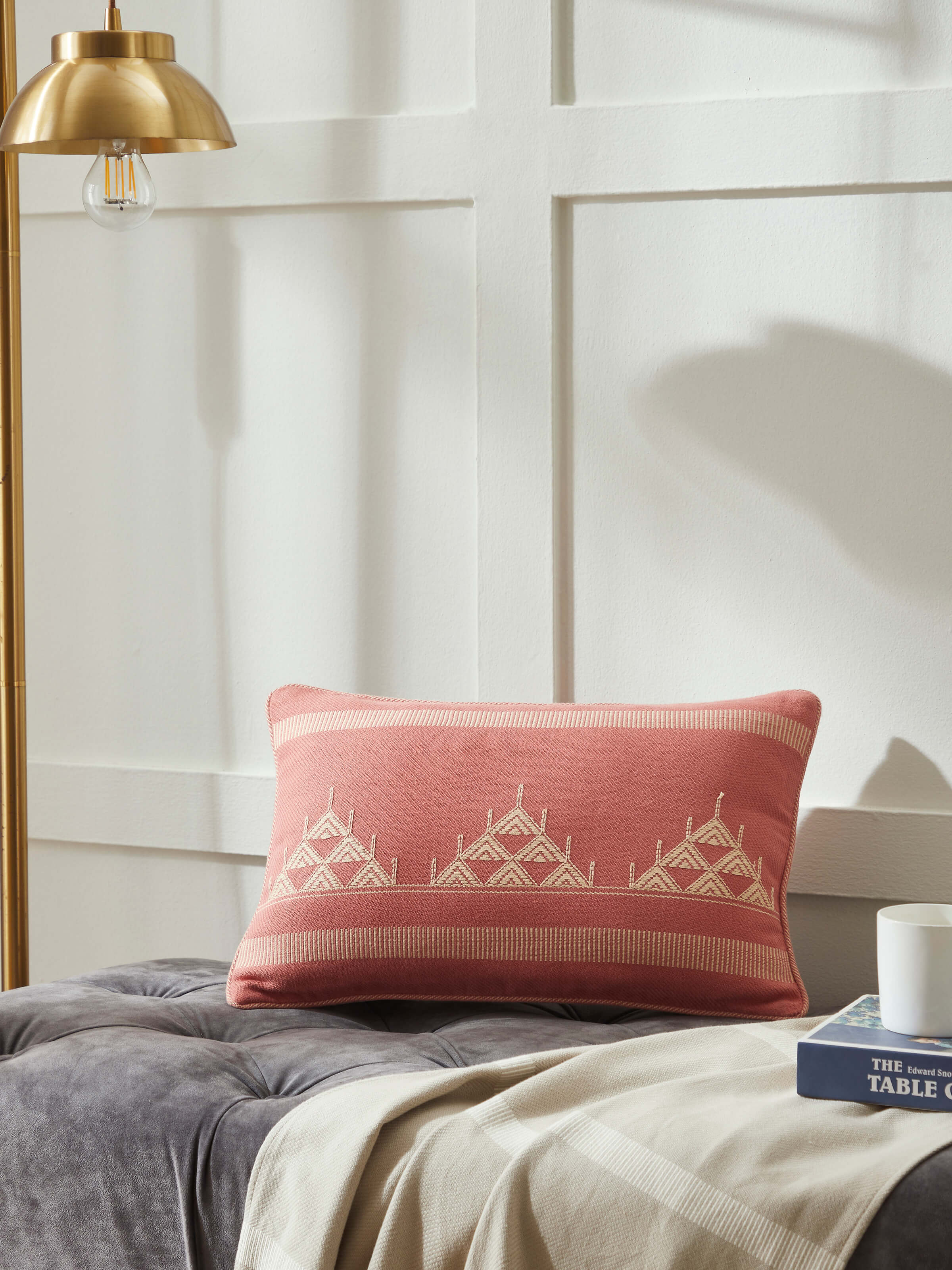 Lifestyle image of peach cotton cushion cover with traditional Buta motif