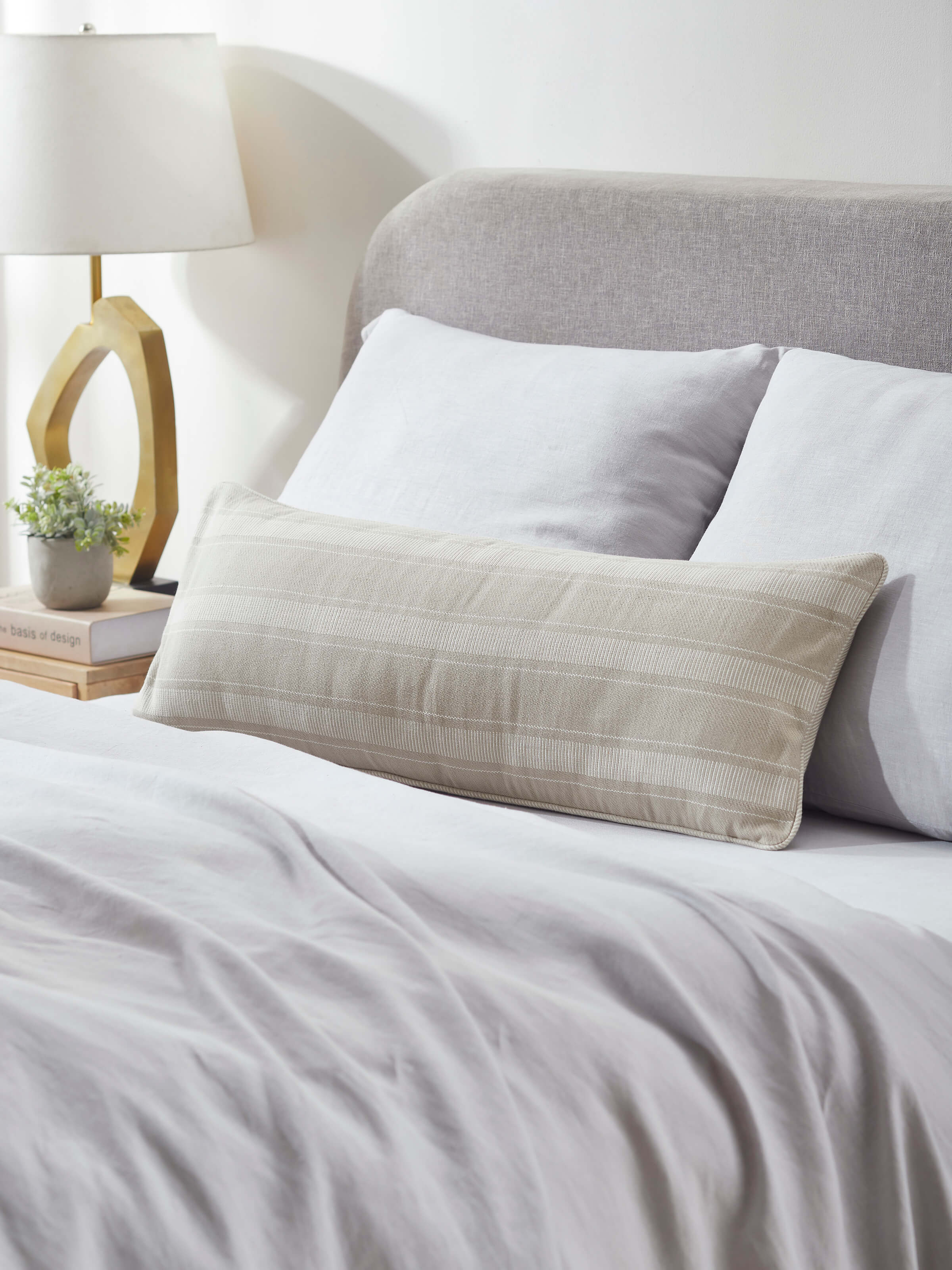 Side view of Godna Light Beige Stripe Cotton Handwoven Pattu Lumbar Cushion Cover displaying texture and pattern.