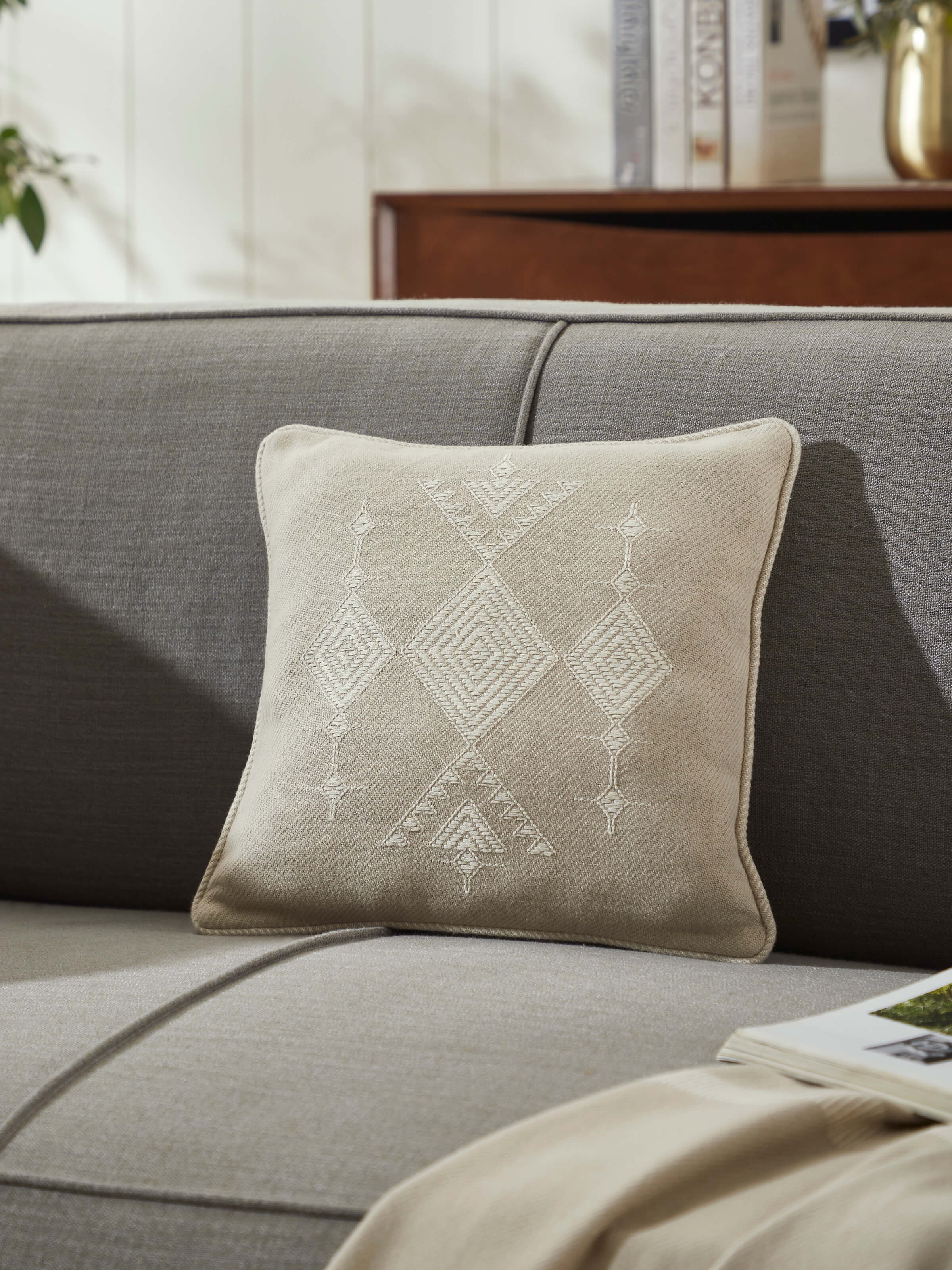 Close-up of Godna light beige buta cotton handwoven pattu cushion cover, showing the detailed handwoven pattern and light beige color.