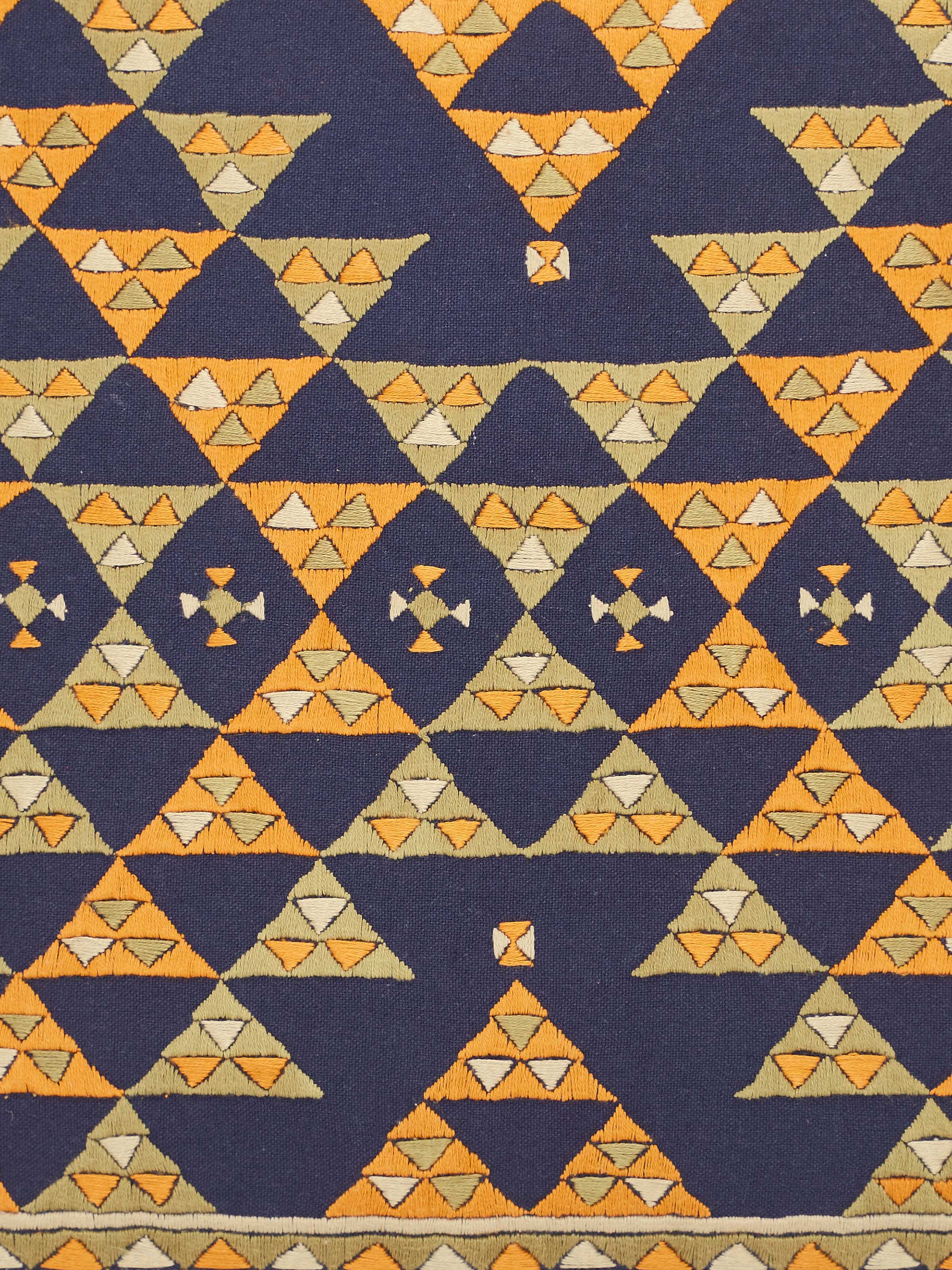 Detail shot of Suf embroidery on blue cotton cushion cover showing fine hand stitching