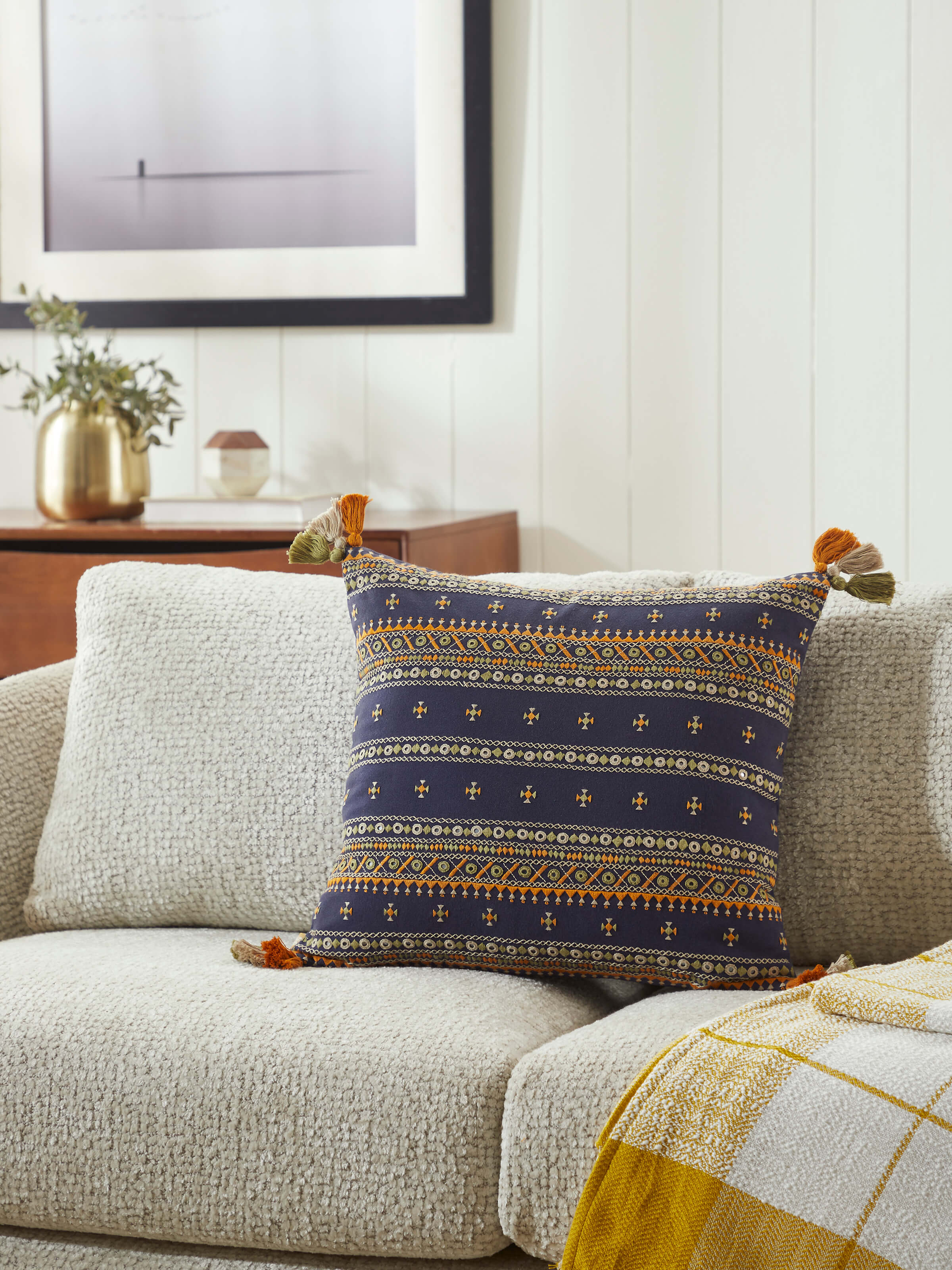 Lifestyle view of Neel Blue Stripe Cotton Cushion on a sofa, adding elegance to the setting.
