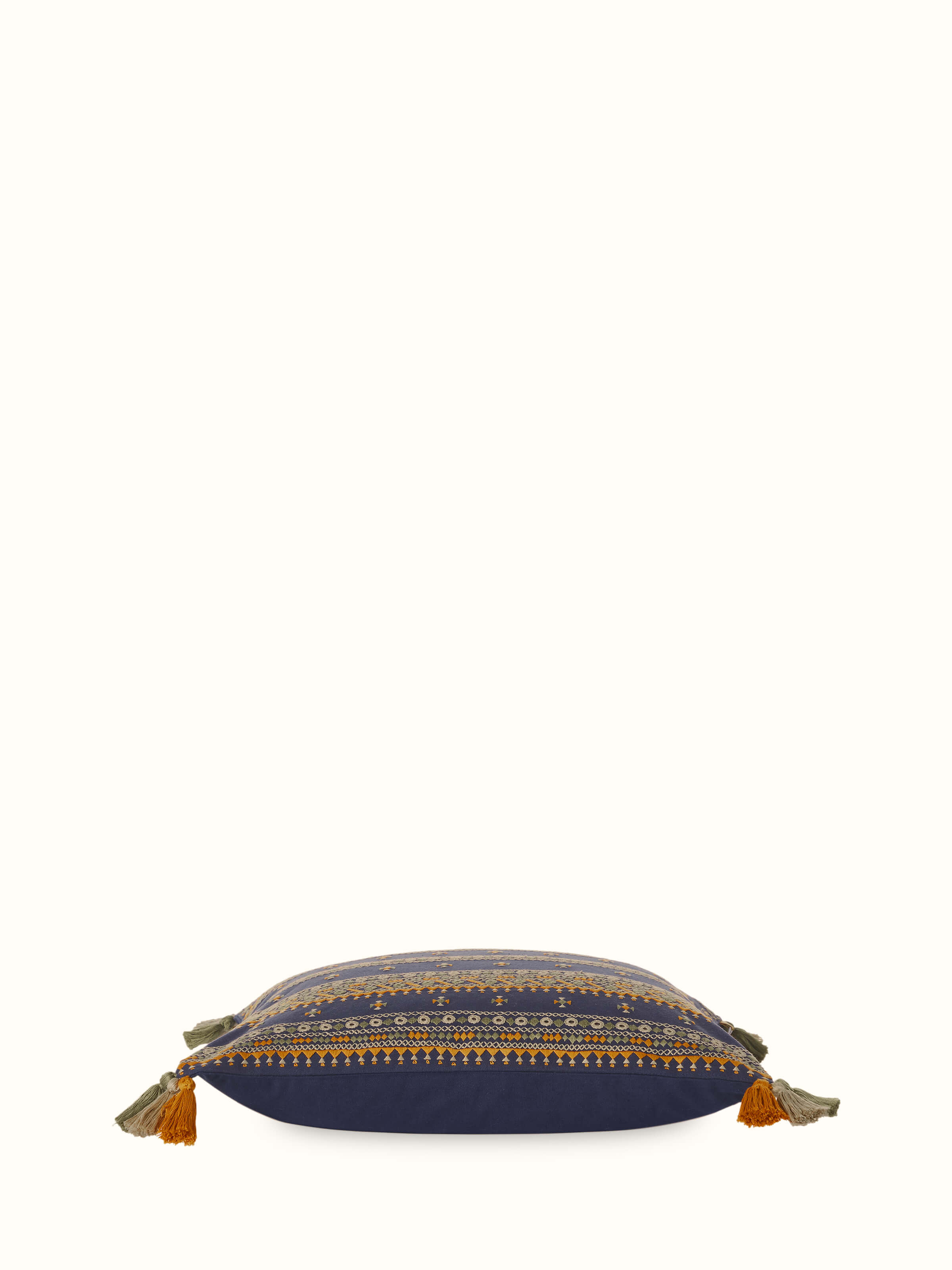 Angled view of Neel Hand Embroidered Cushion Cover, highlighting blue stripes and artisan details.