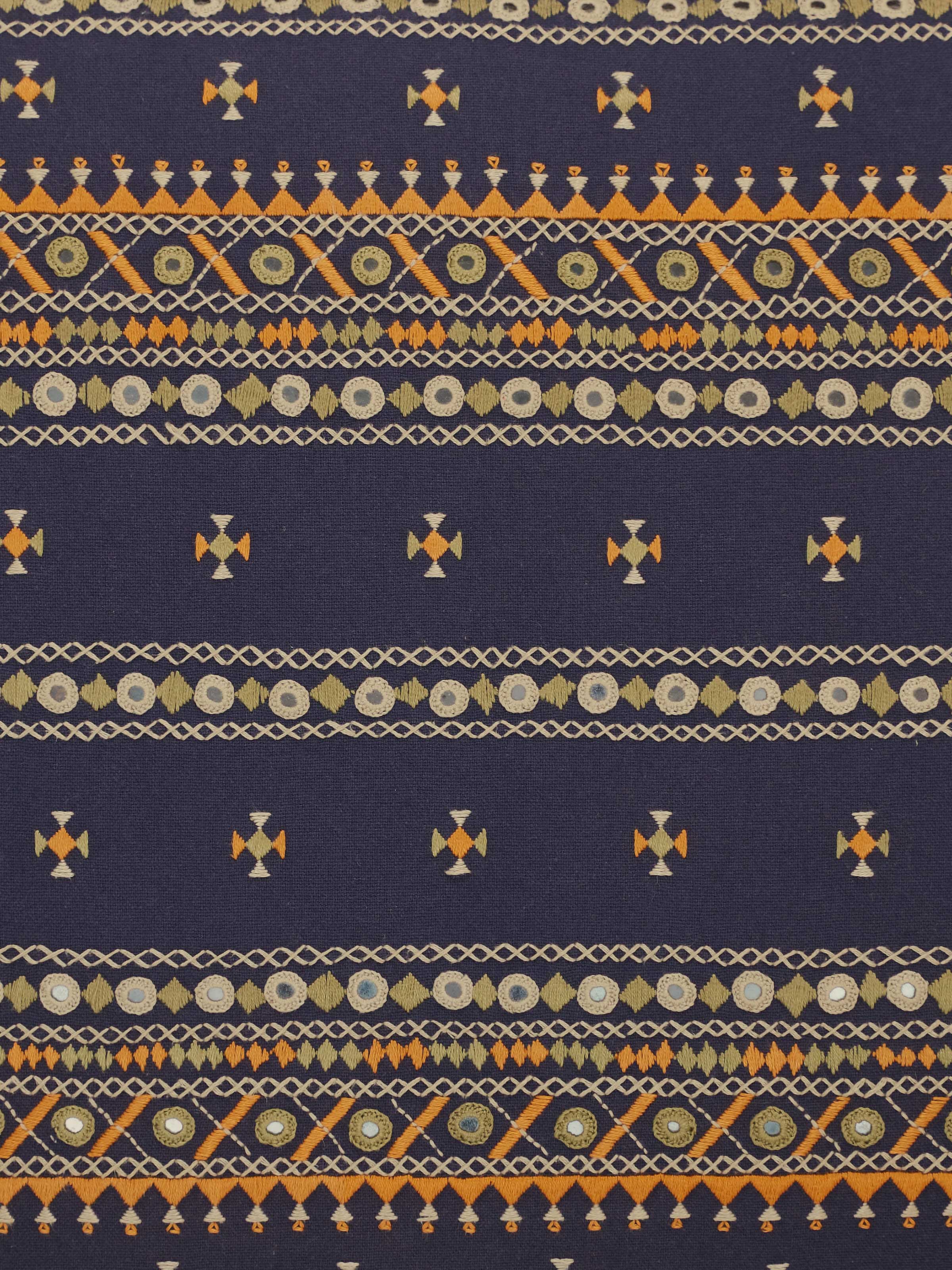 Detail shot of Neel Cushion Cover embroidery, showing fine hand-stitched motifs on cotton.