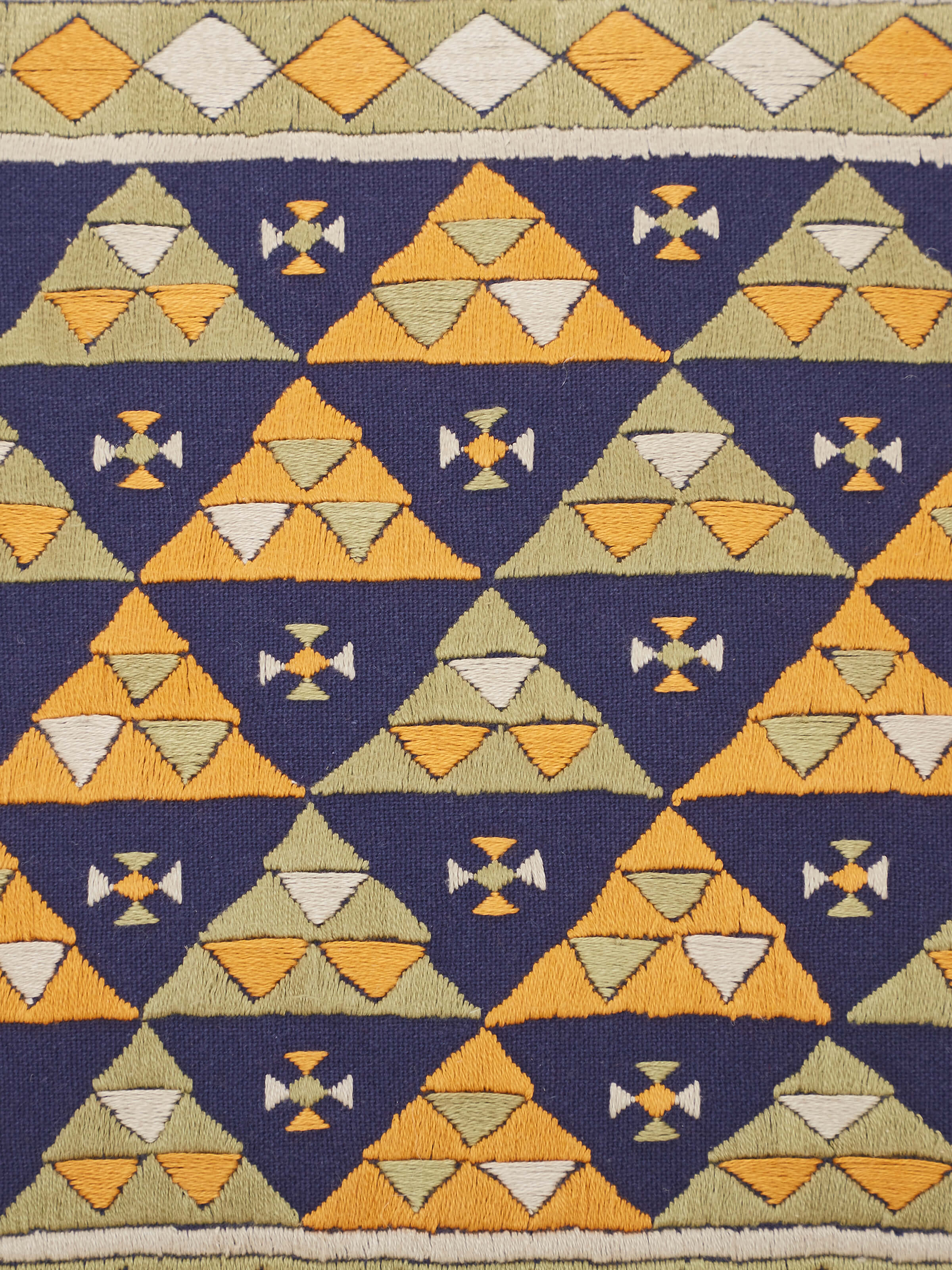 Perspective view of Neel blue triangular allover cotton casement suf hand embroidered cushion cover displaying the overall design.