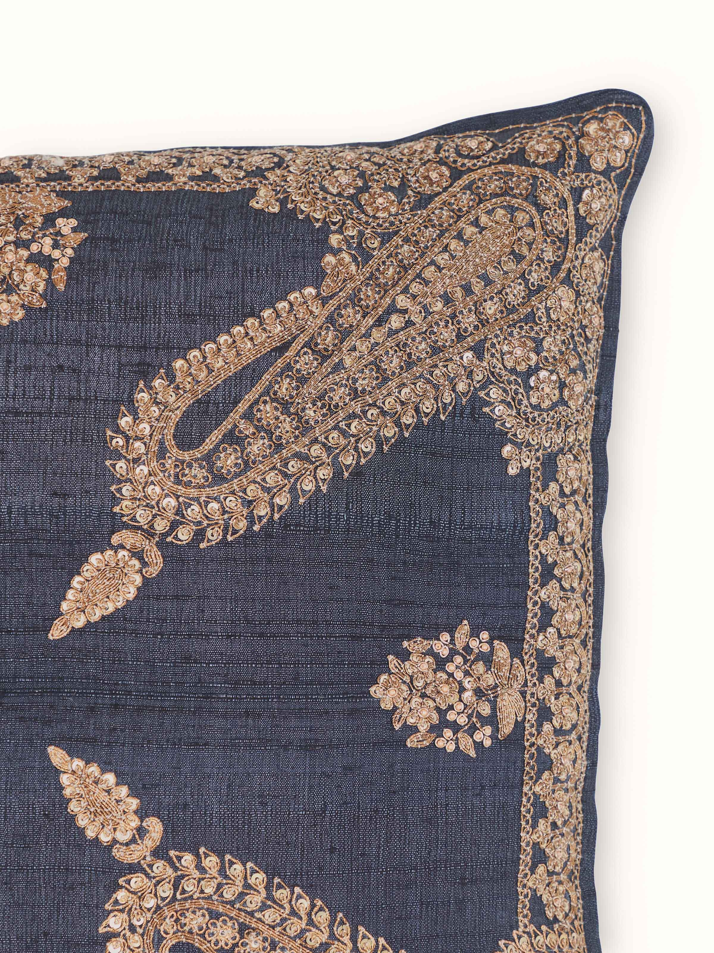 Perspective view of Alankar dark blue koniya paisley silk zardozi embroidered cushion cover highlighting the paisley design and embroidery.