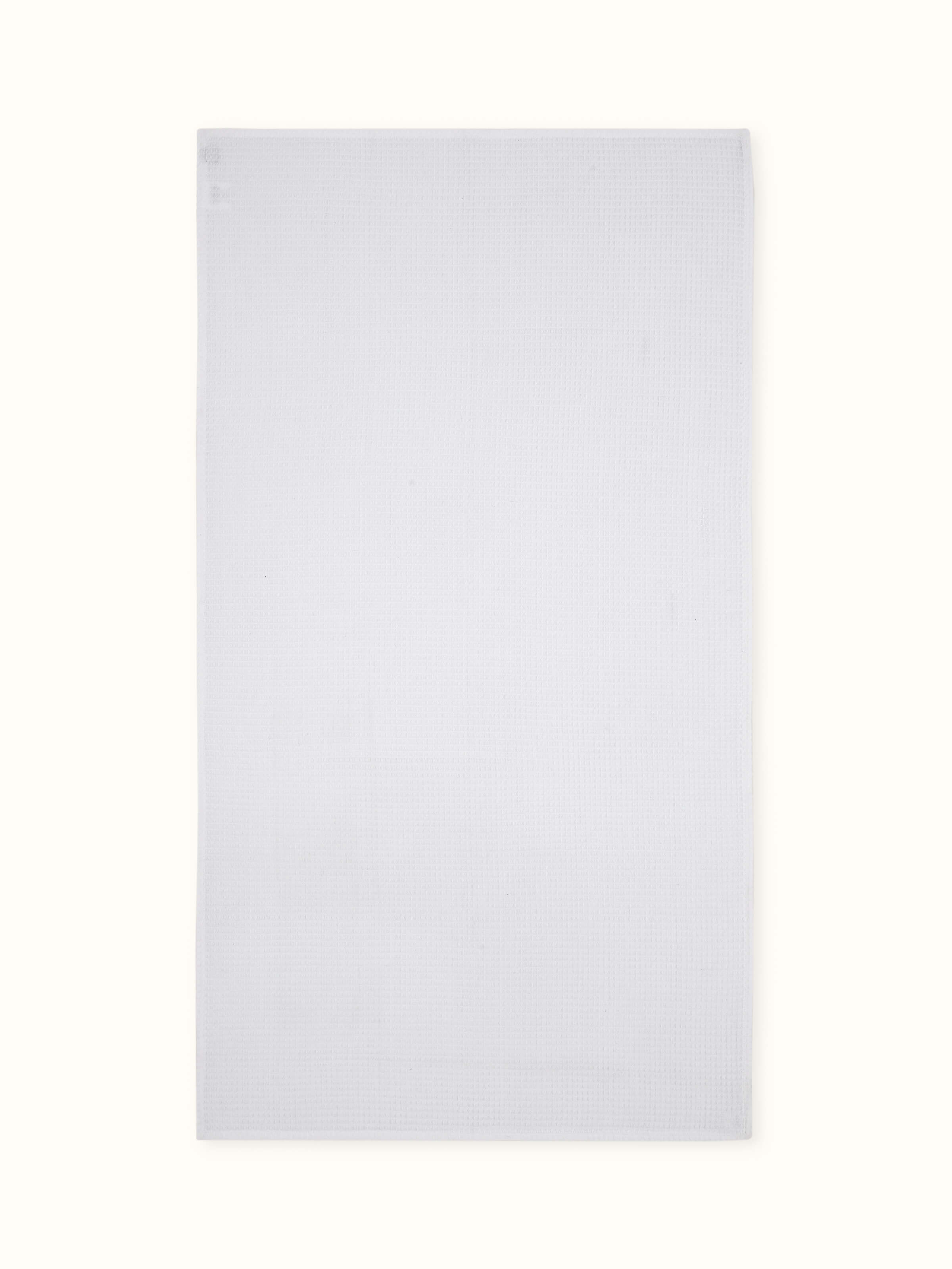 Front view of Amala waffle white solid cotton bath towel (M), displaying the towel's waffle texture and pure white color