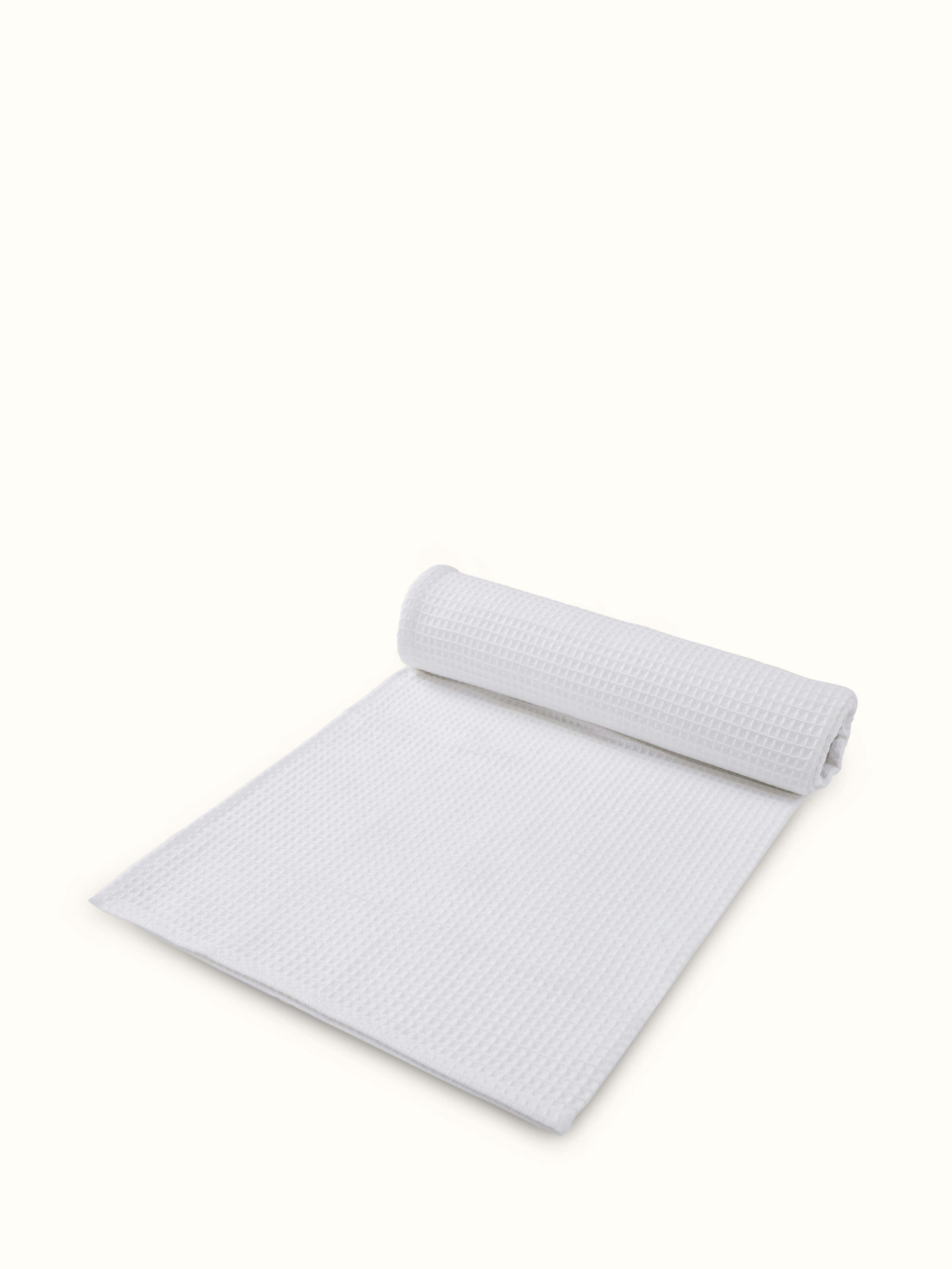 Detailed side view of Amala waffle white solid cotton bath towel (M), showing the towel's thickness and absorbent texture