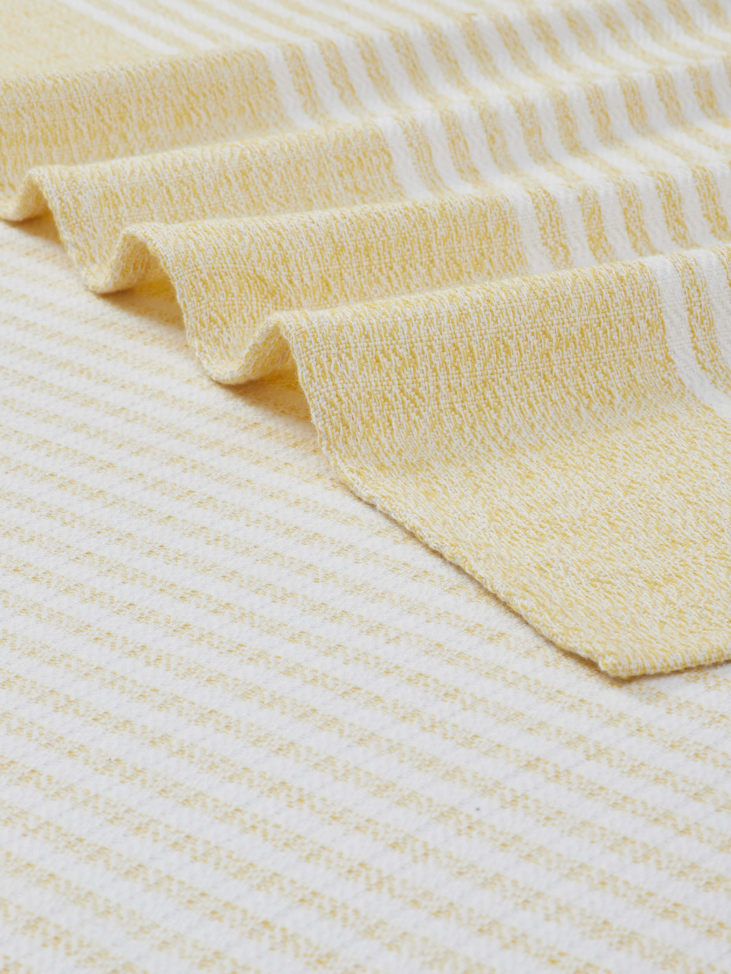 Full view of Vayana solid yellow cotton bath towel (XL) showing the towel spread out and its bright yellow hue