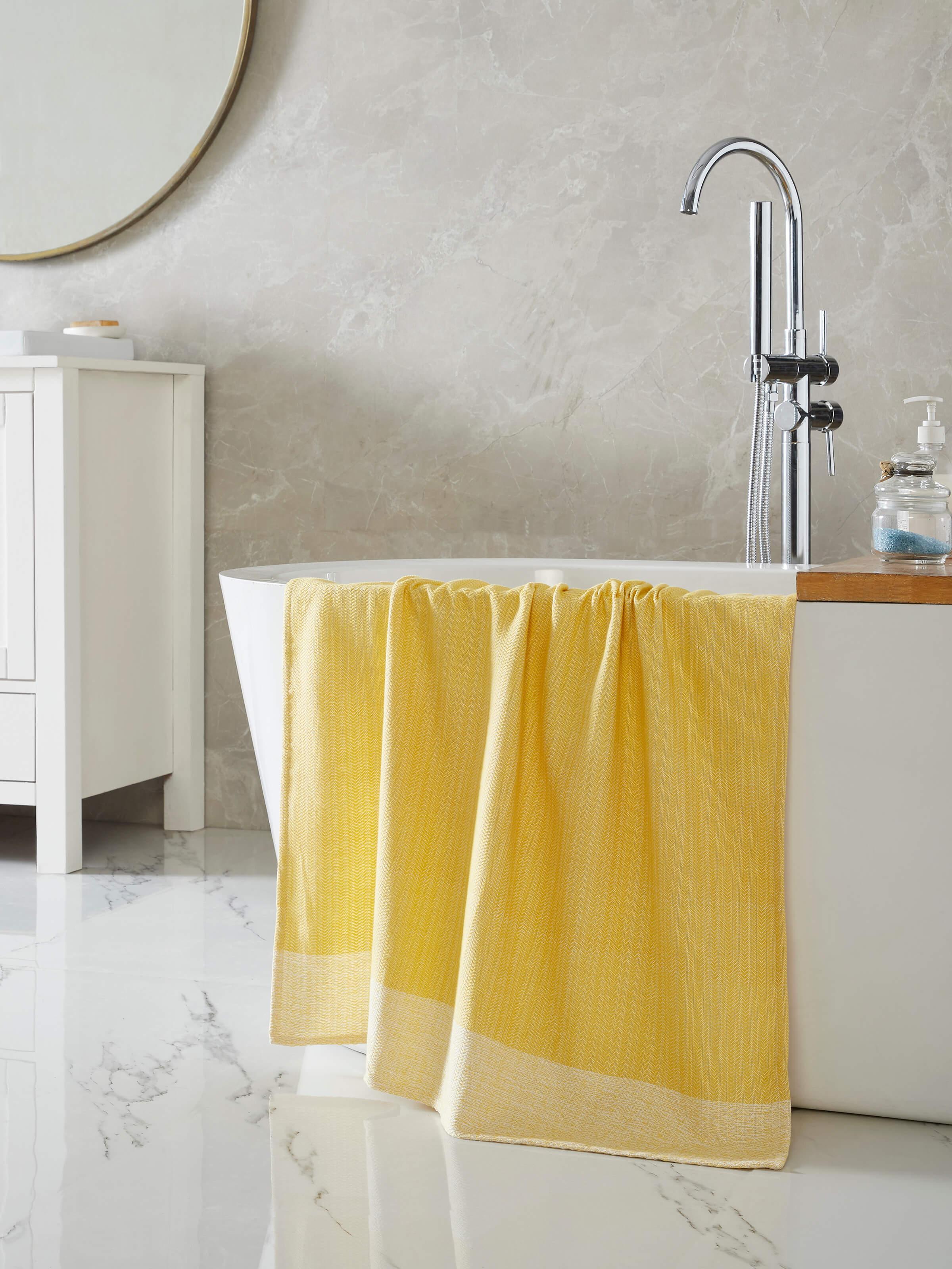 Close-up of Vayana solid yellow stripe cotton bath towel (L) highlighting the stripe pattern and cotton texture