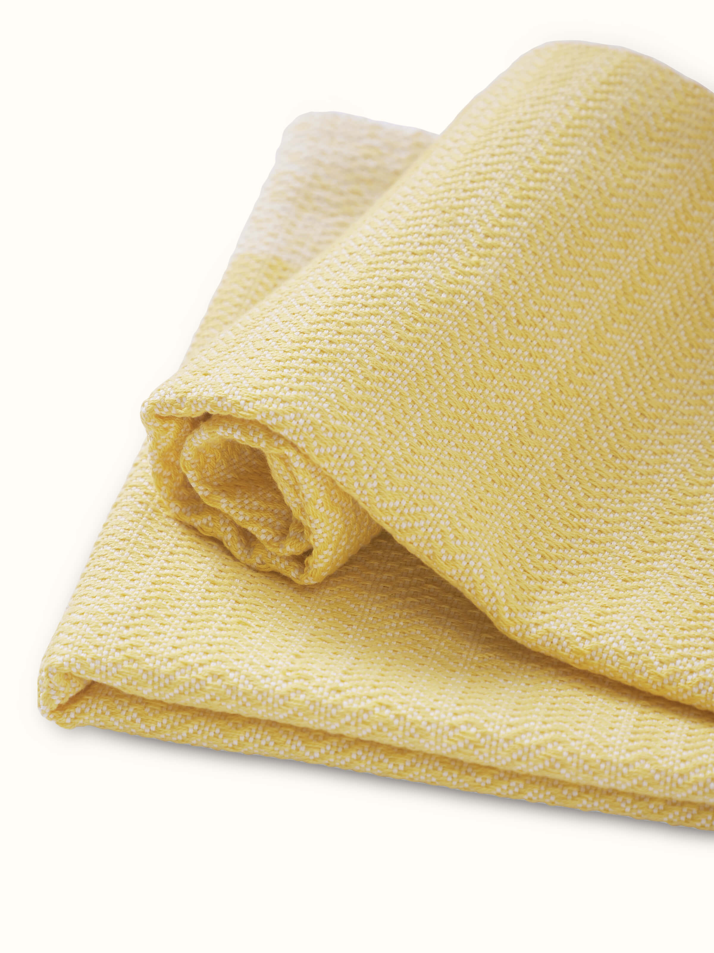 Artistic view of Vayana solid yellow stripe cotton hand towels in a bathroom setting