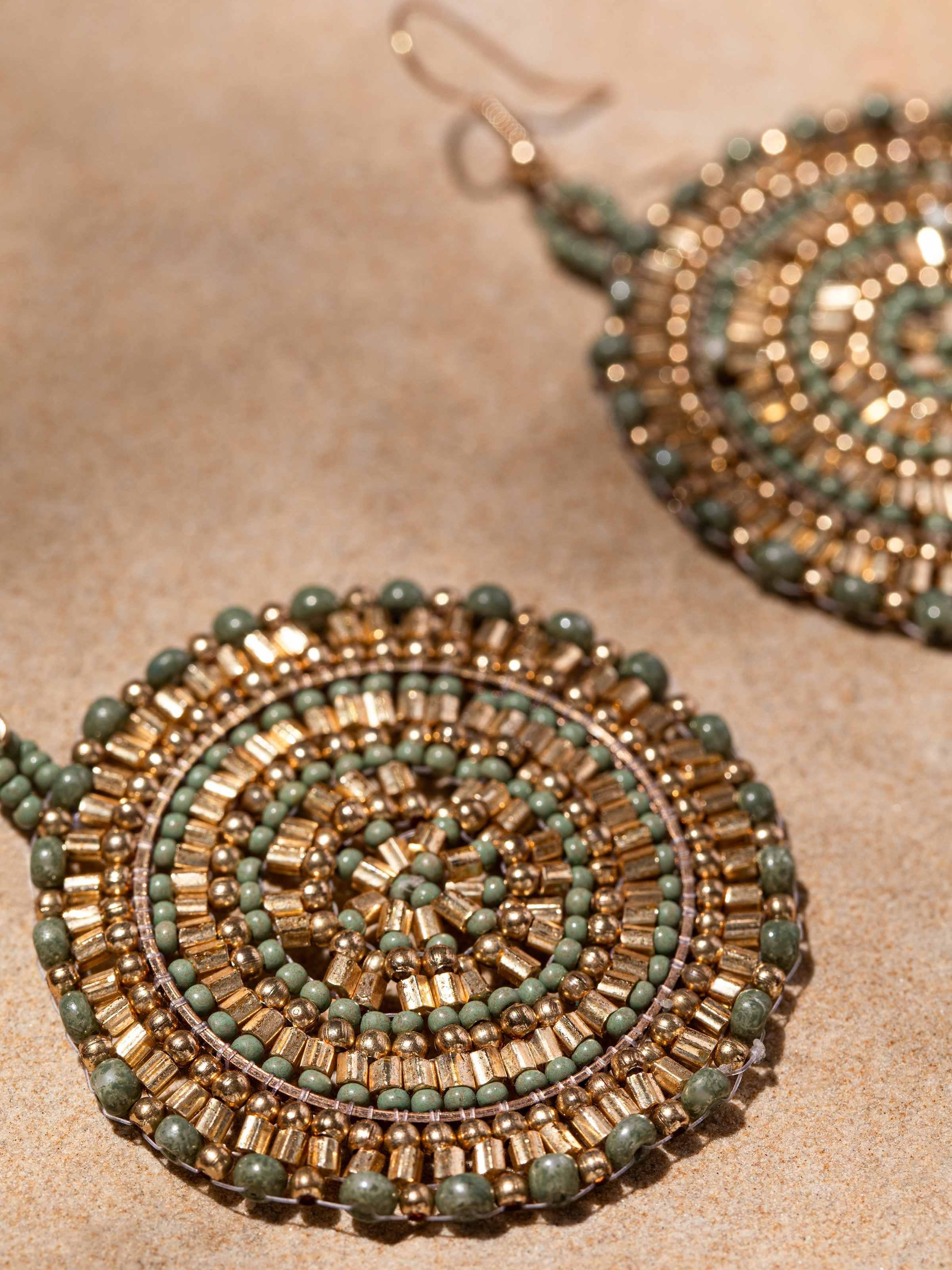 Back view of handcrafted drop earrings displaying the secure clasp and overall construction.