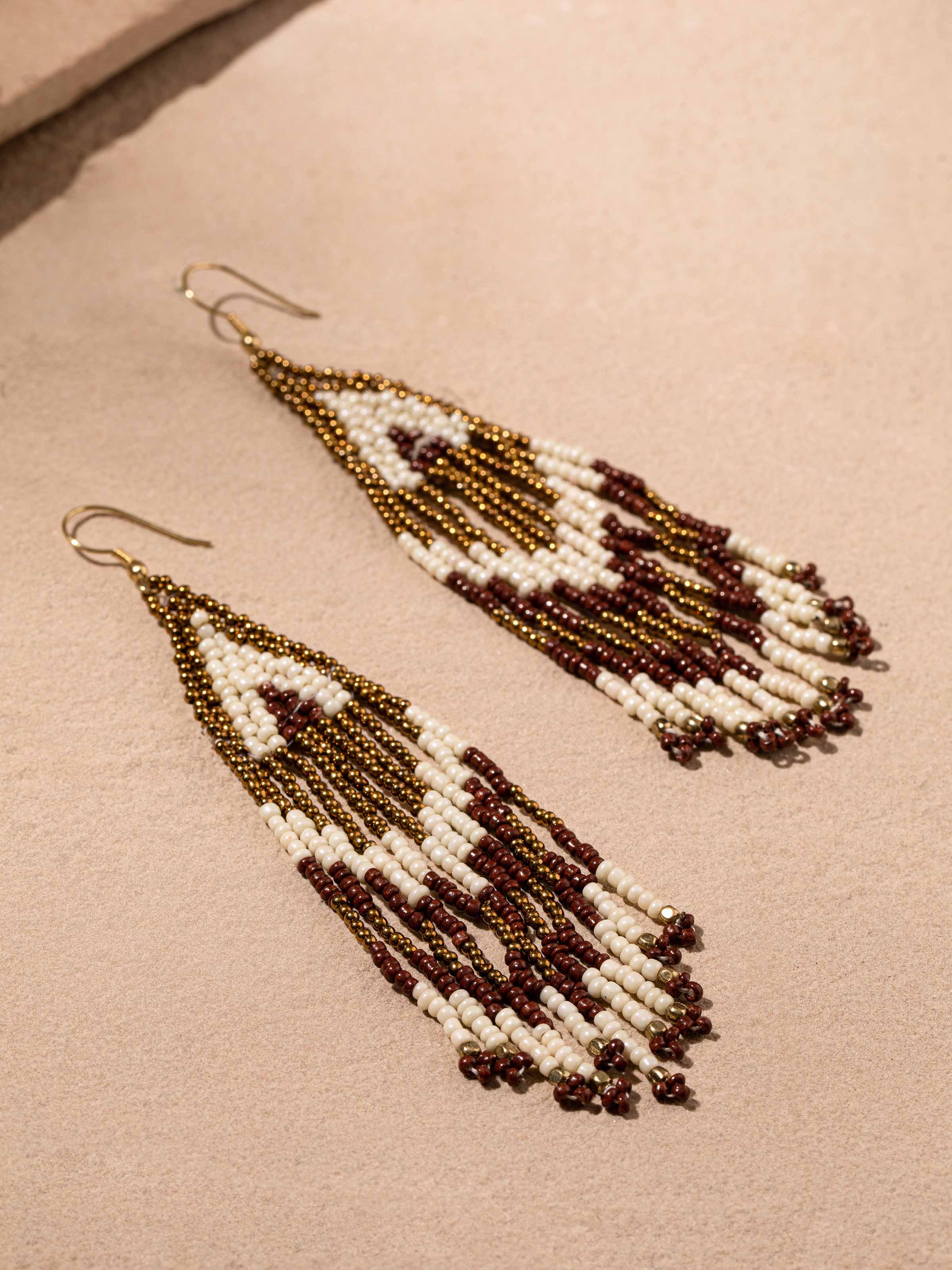 Side view of handcrafted drop earrings showcasing detailed artistry.