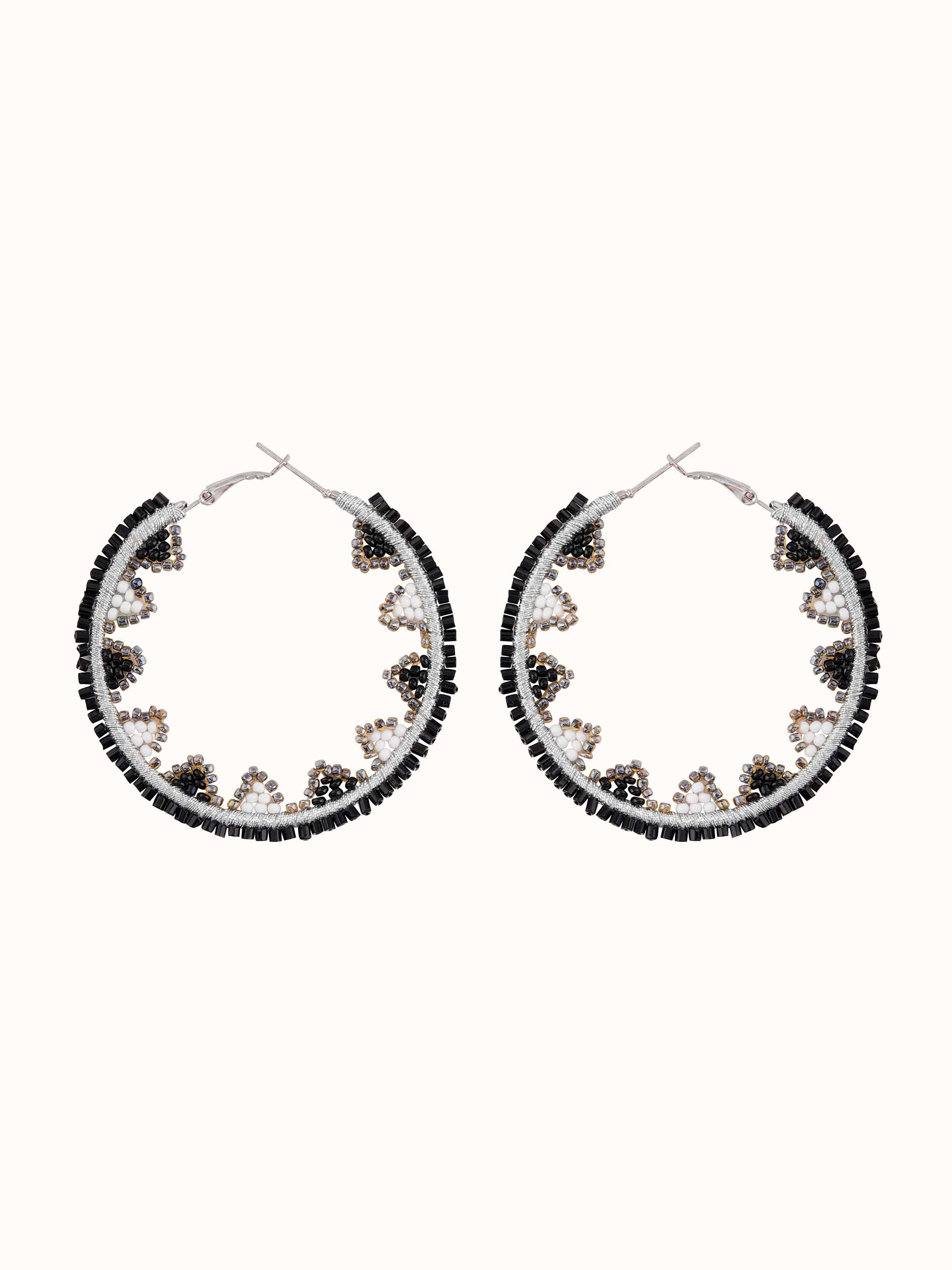 Front view of handcrafted hoop earrings with intricate design