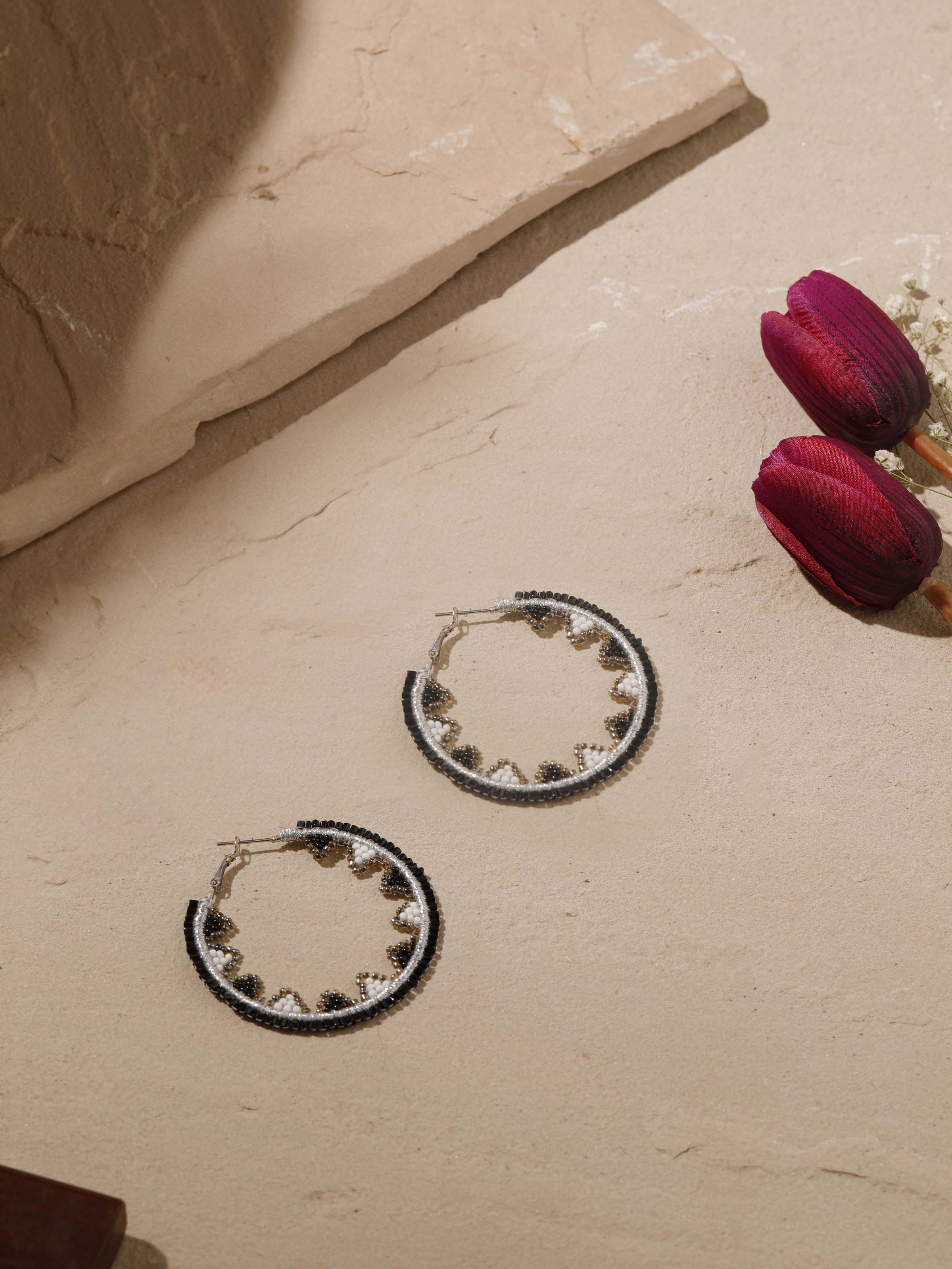 Close-up view of handcrafted hoop earrings highlighting fine detailing