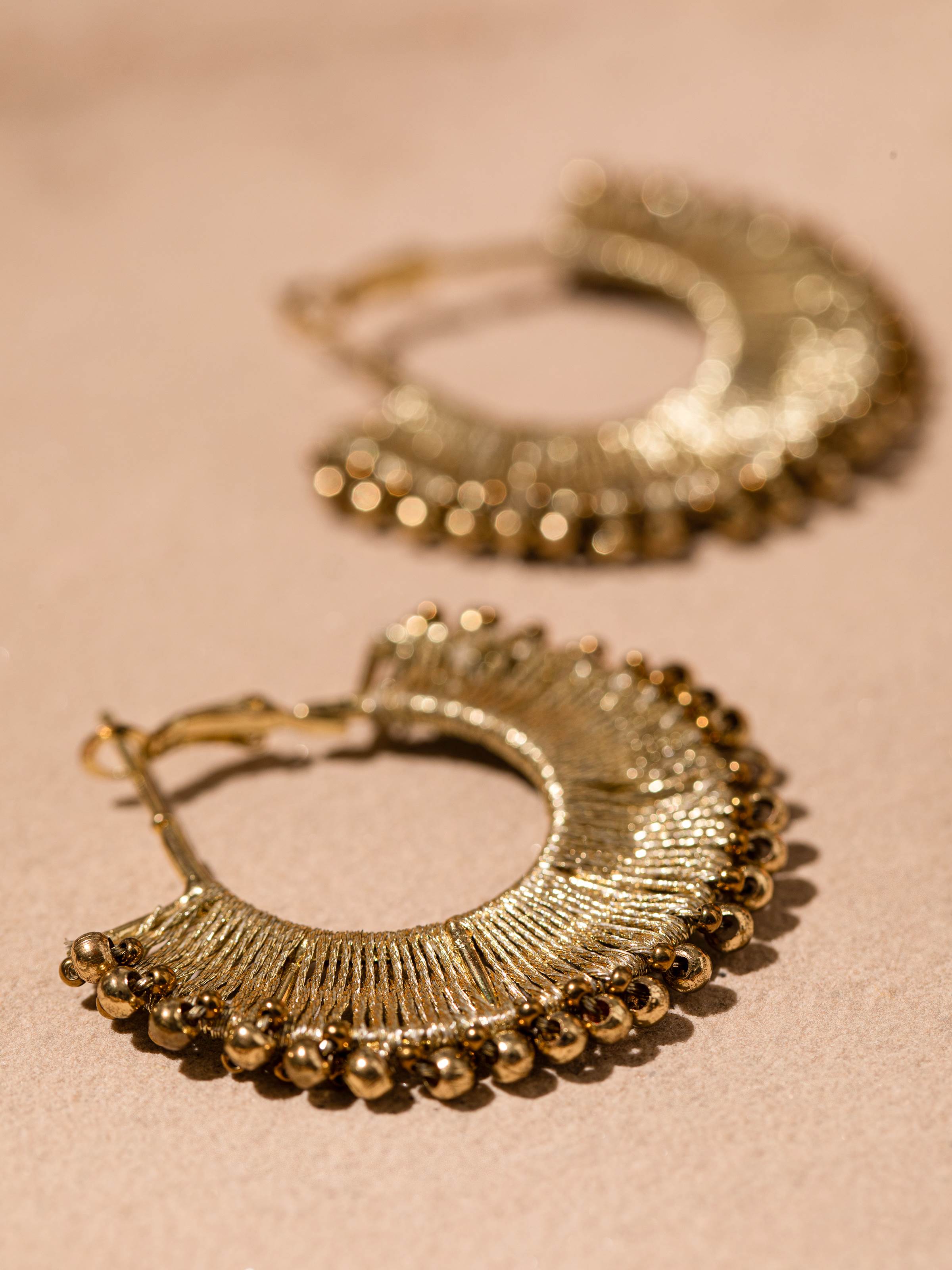 Detailed view of Handcrafted Hoop Earrings emphasizing the unique design and meticulous craftsmanship.