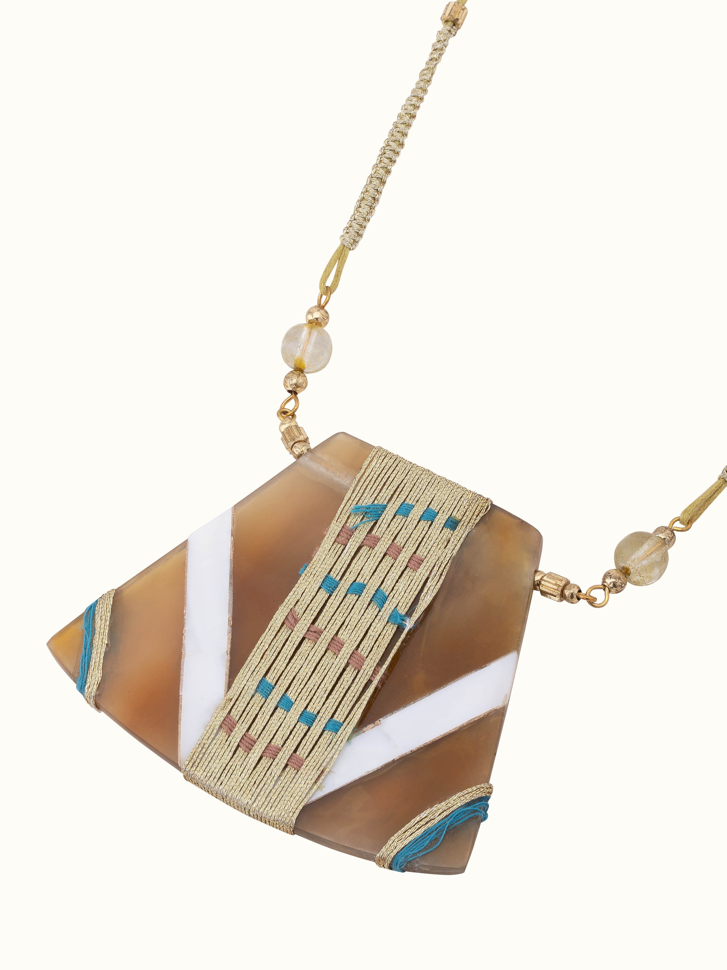 Handcrafted long necklace displayed on a flat surface showing its detailed design and elegant craftsmanship.