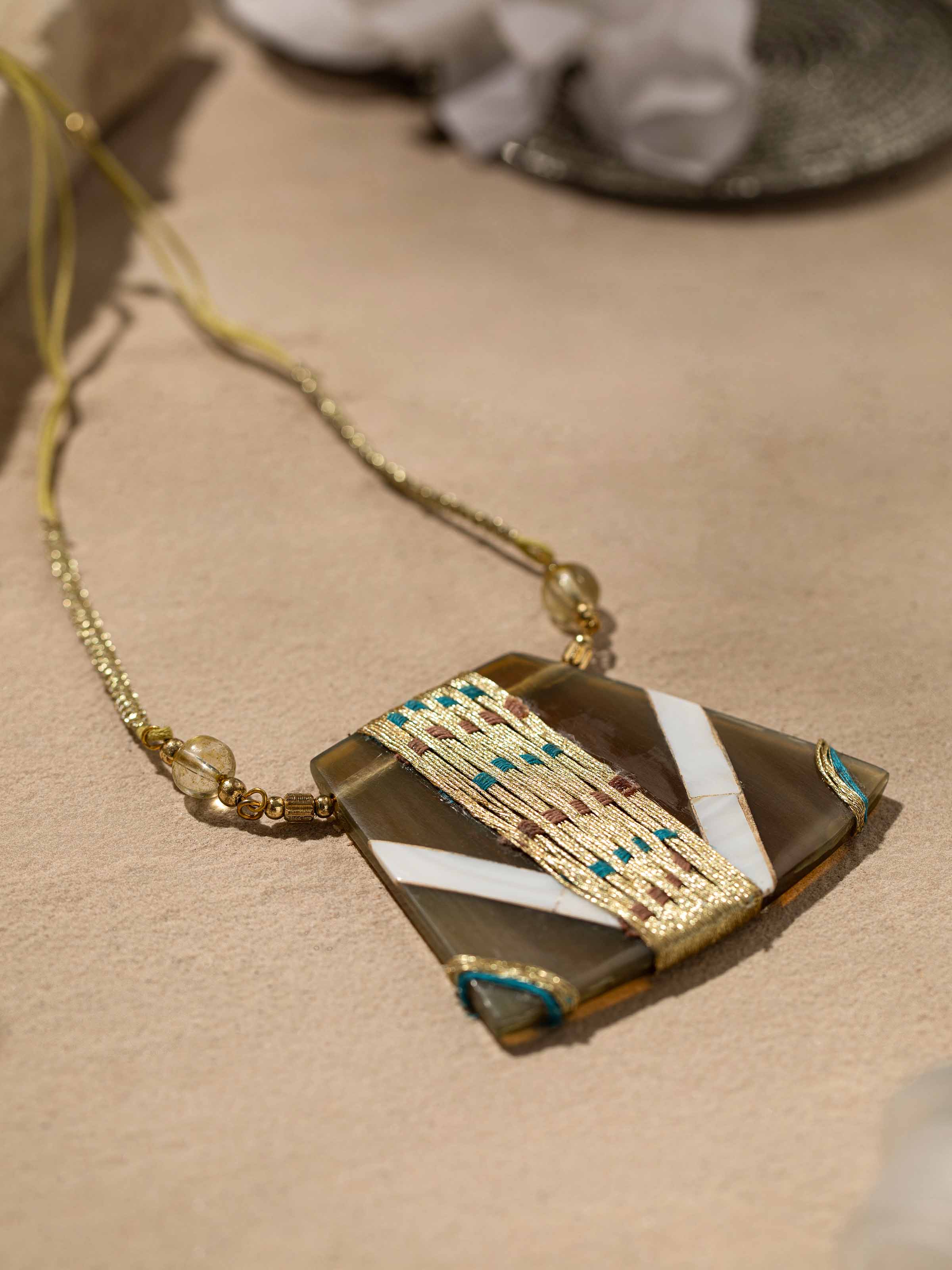 Detailed view of handcrafted long necklace showcasing its fine craftsmanship and stylish design.