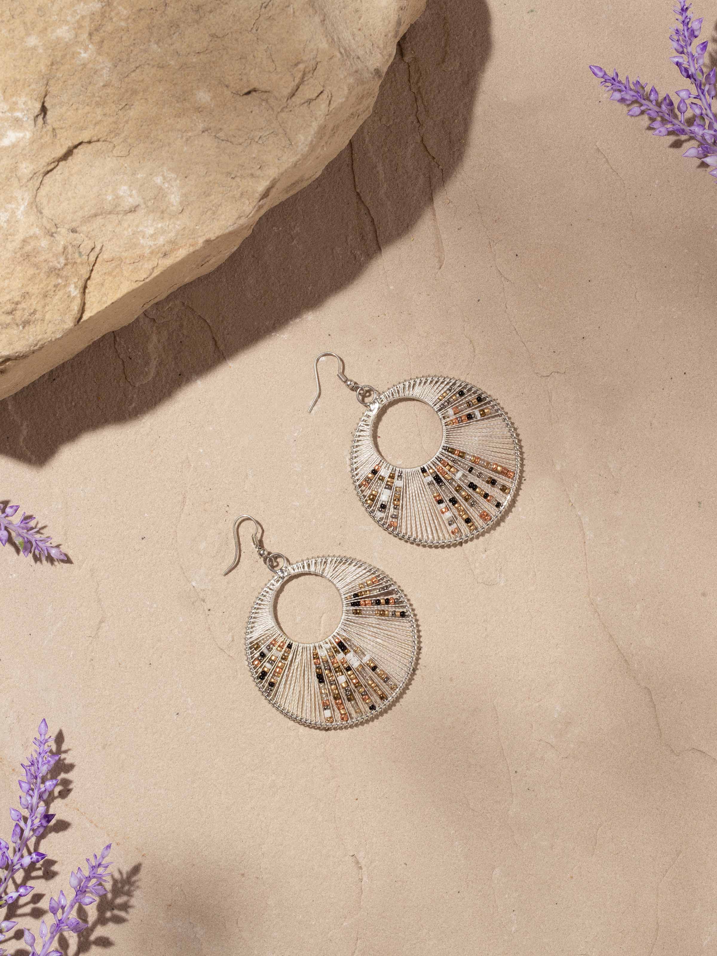 Close-up view of handcrafted drop earrings highlighting intricate details and finish.