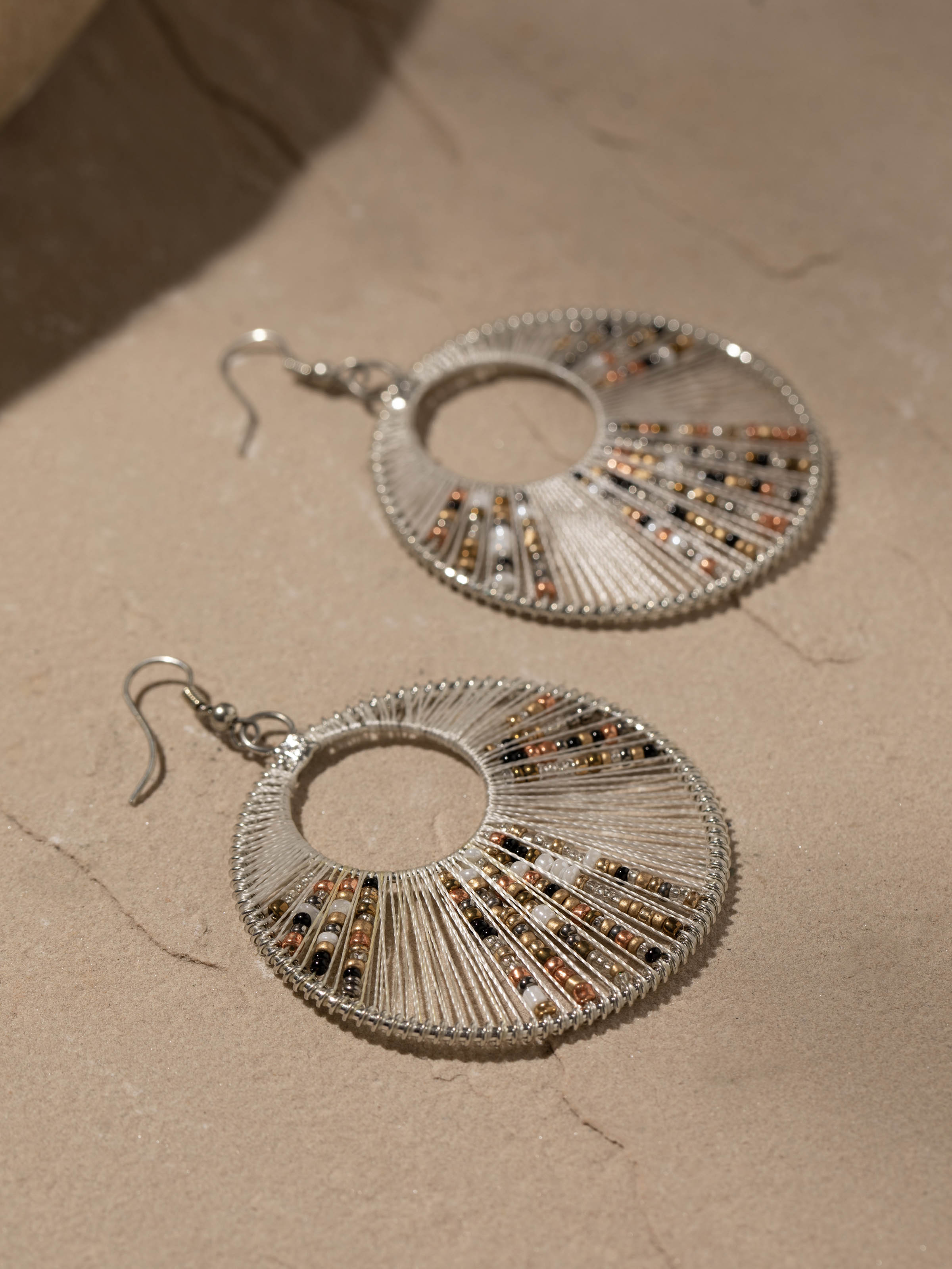 Back view of handcrafted drop earrings highlighting the closure and earring design.