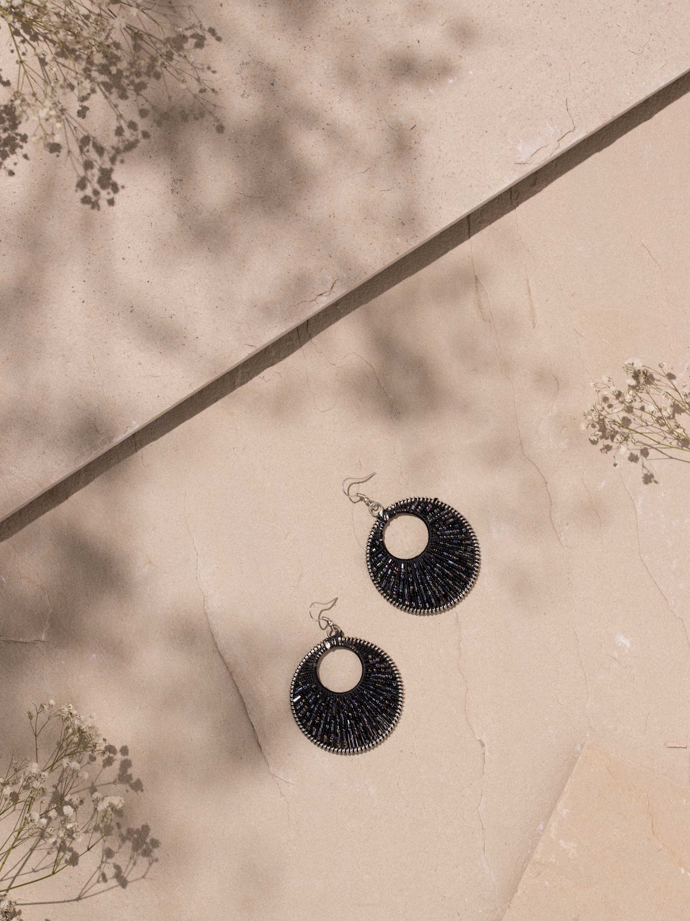 Close-up view of handcrafted drop earrings highlighting the fine details